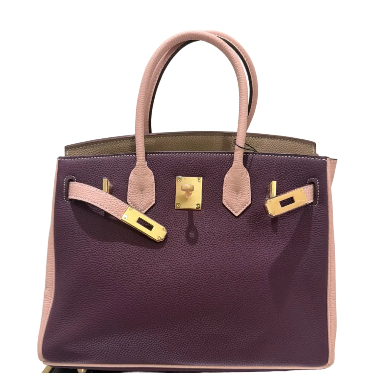 Purple handbag with gold hardware on a light gray background