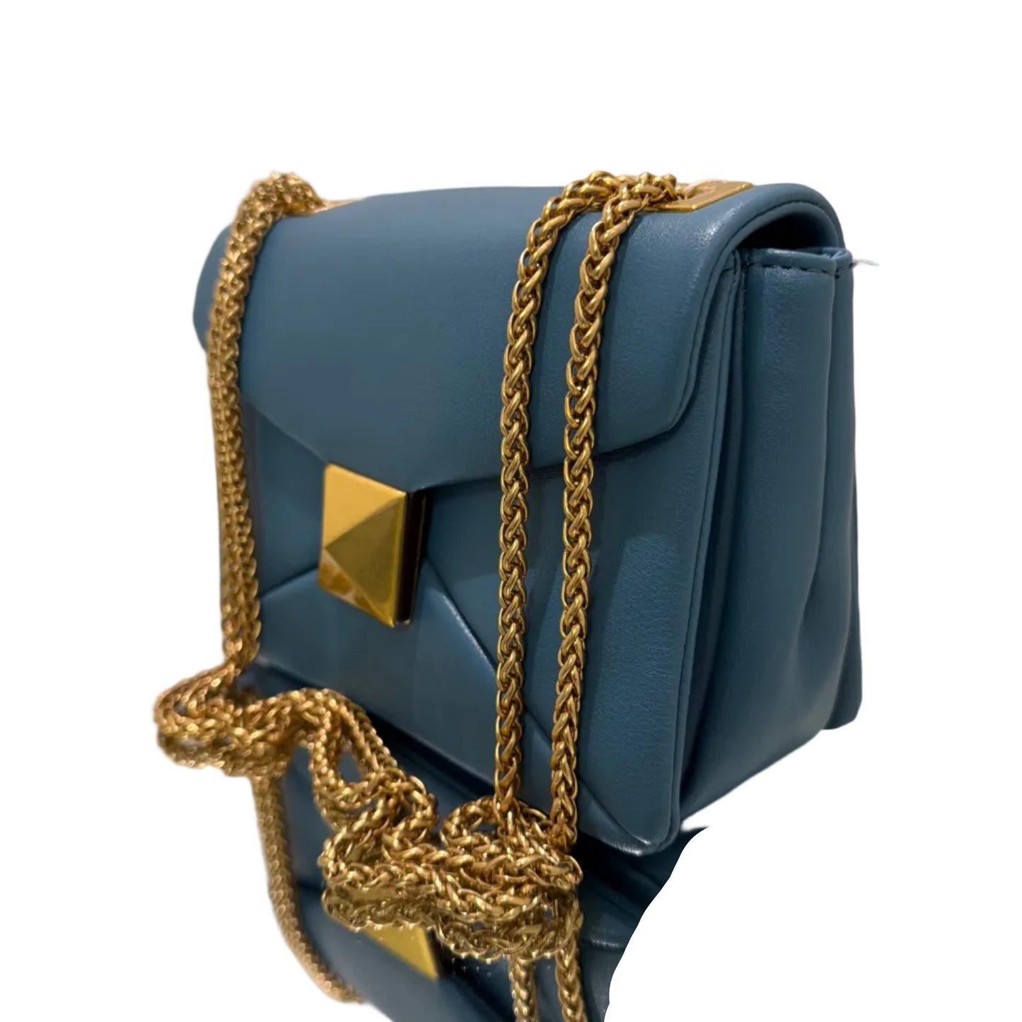 Blue handbag with gold chain strap on a white surface