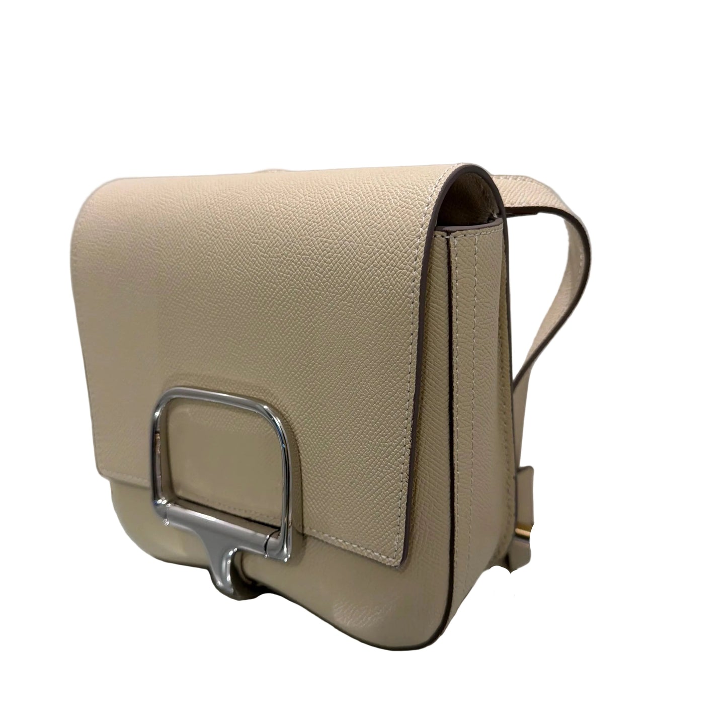 Beige handbag with a metallic clasp on a white surface