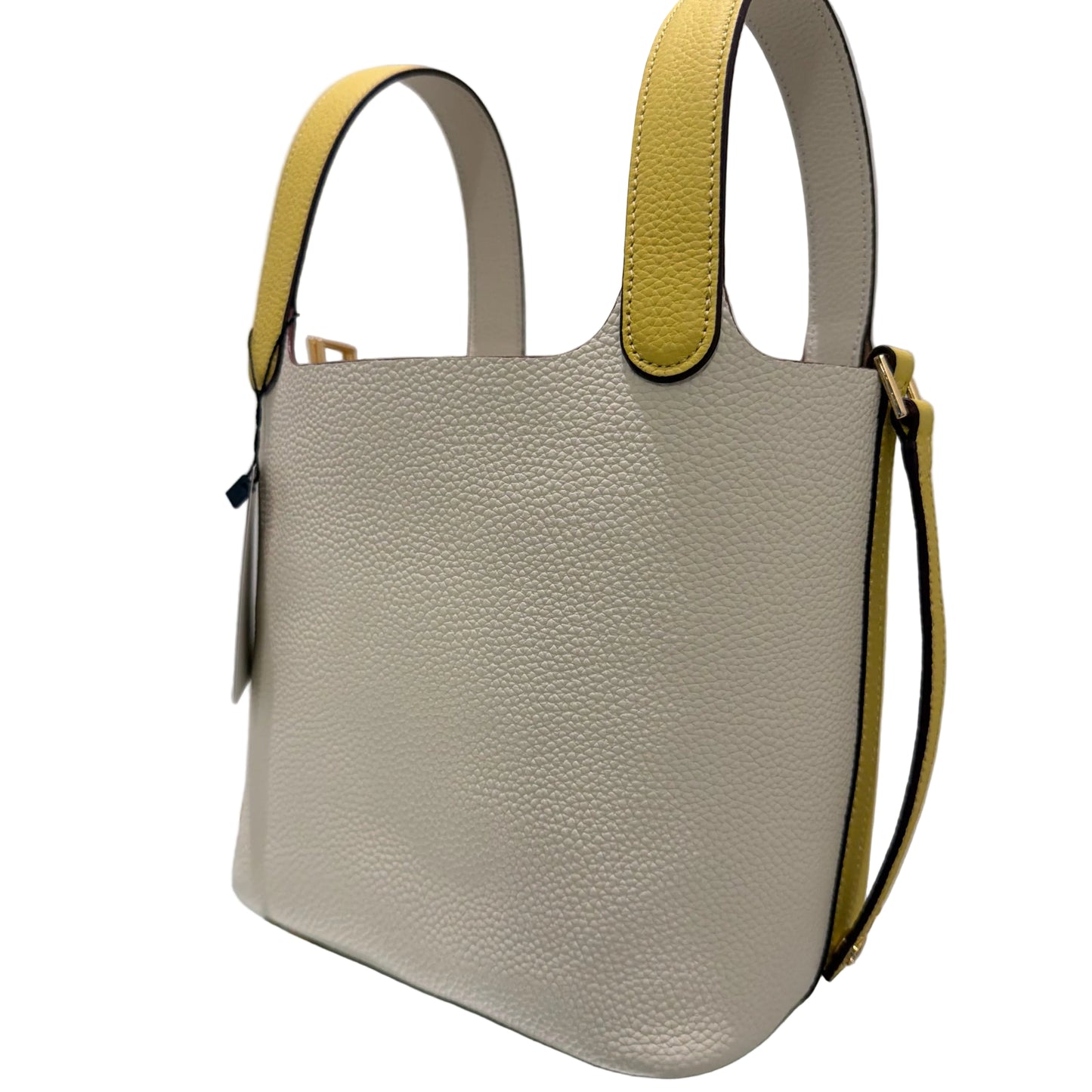 Beige handbag with yellow accents on a white surface