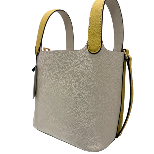 Beige handbag with yellow accents on a white surface