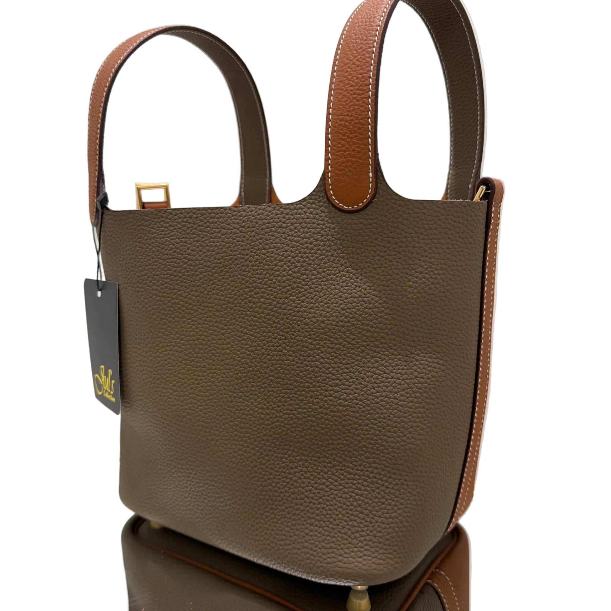 Brown leather handbag with matching strap on a white background