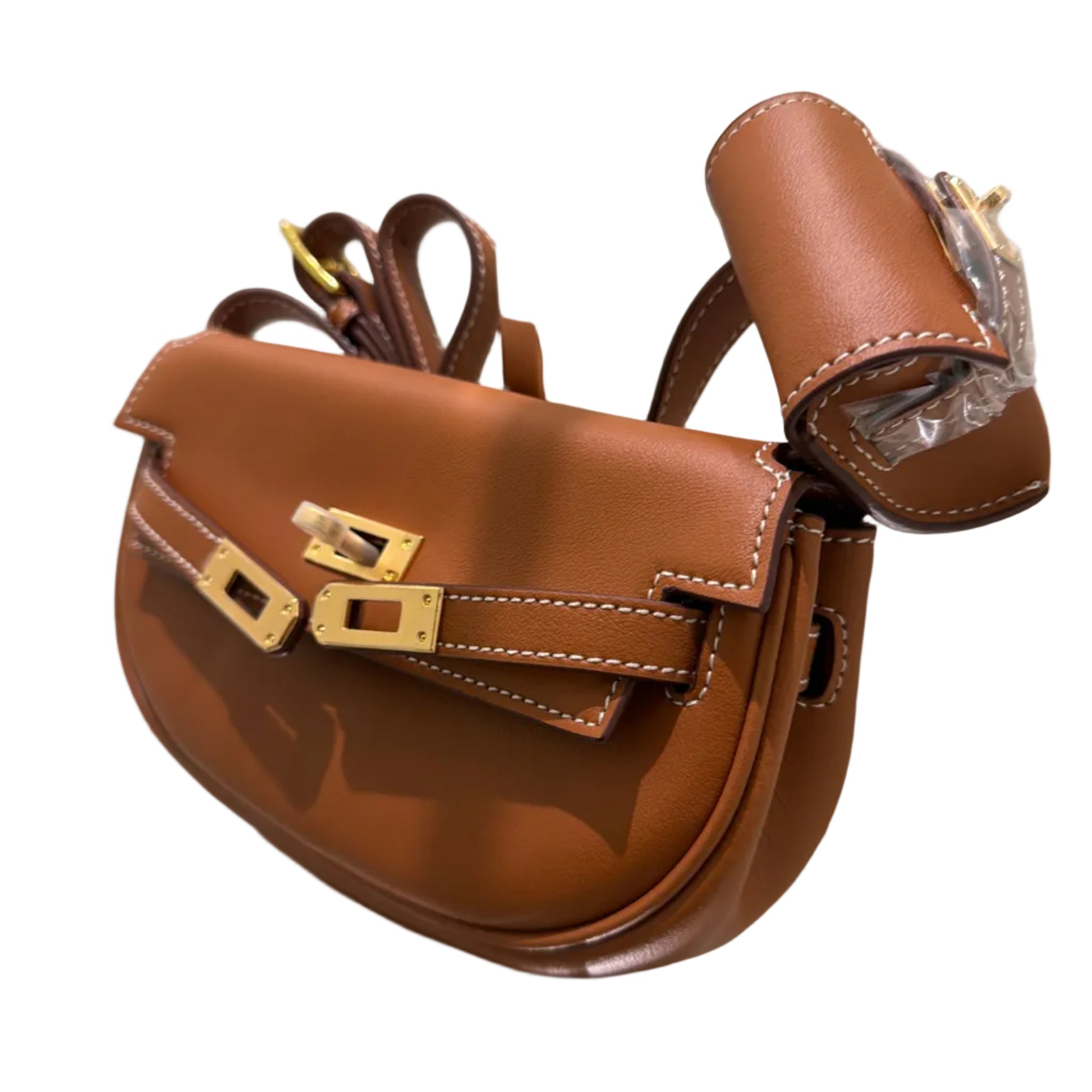 Brown leather bag with gold hardware on a reflective surface
