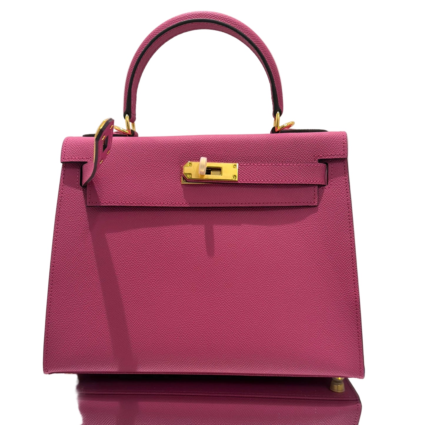 Purple handbag with gold accents on a white background