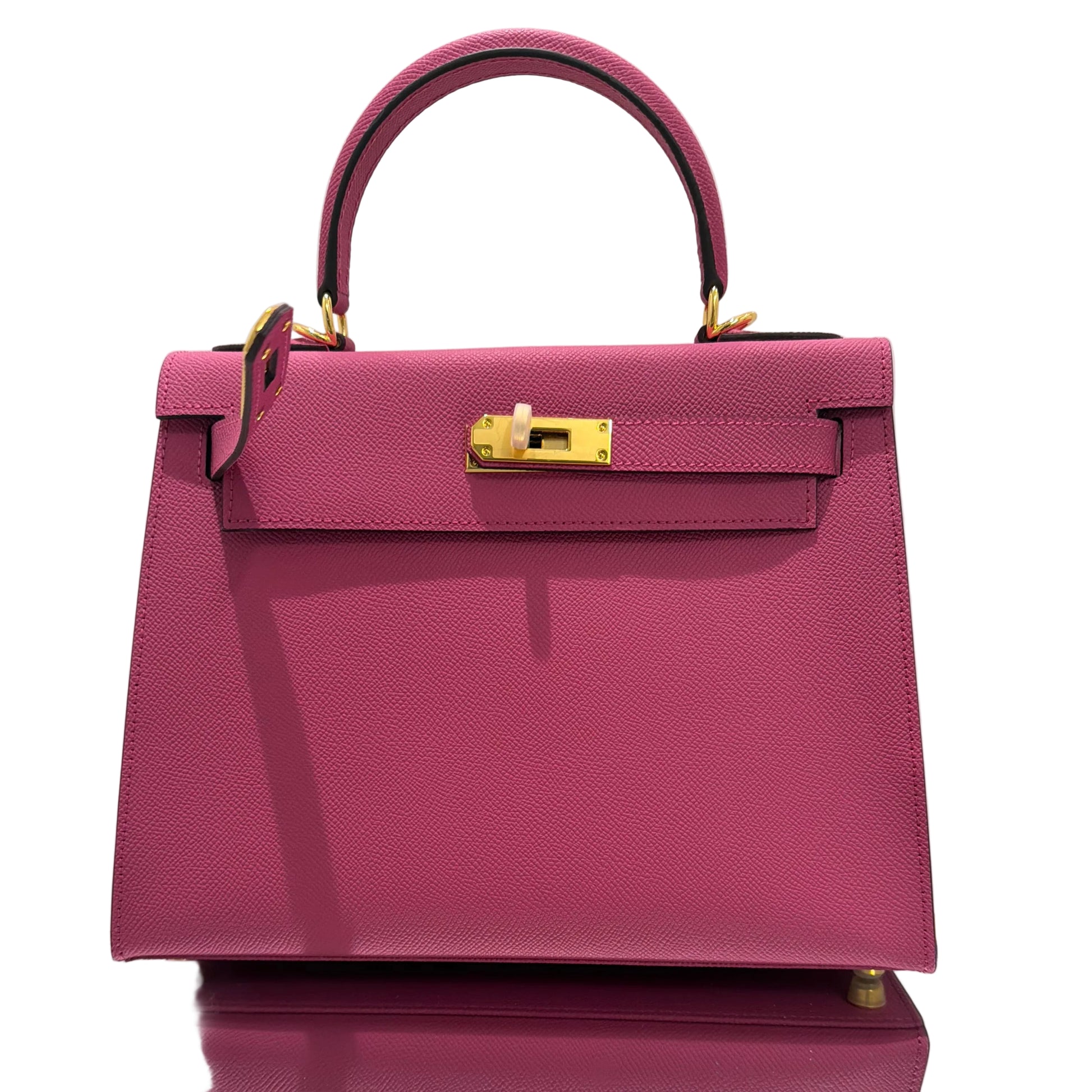 Purple handbag with gold accents on a white background