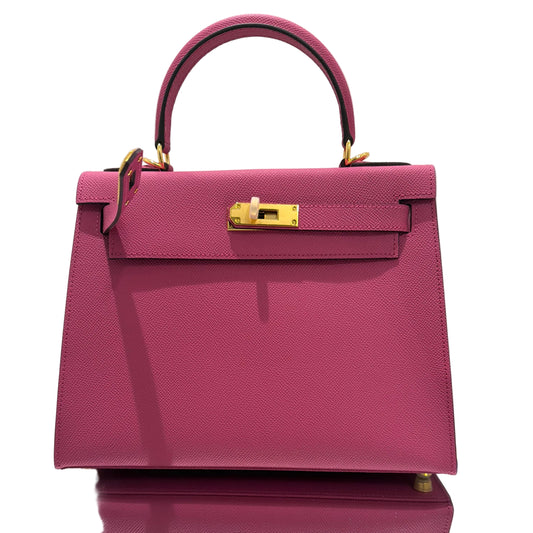 Purple handbag with gold accents on a white background
