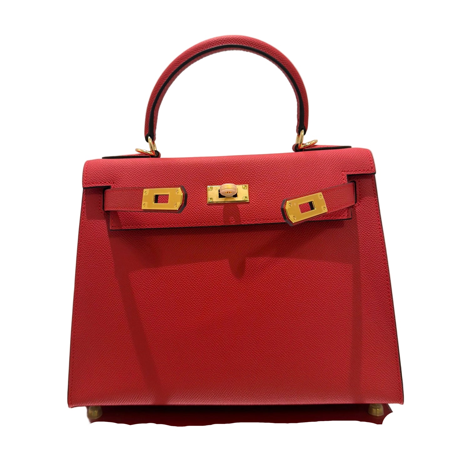 Red handbag with gold hardware on a light gray background