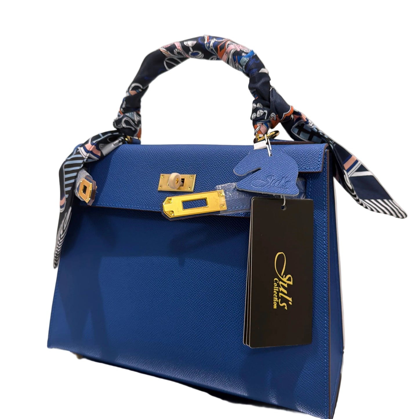 Blue handbag with floral strap and visible brand label on a light background