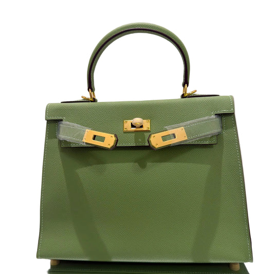 Green handbag with gold hardware on a light gray background