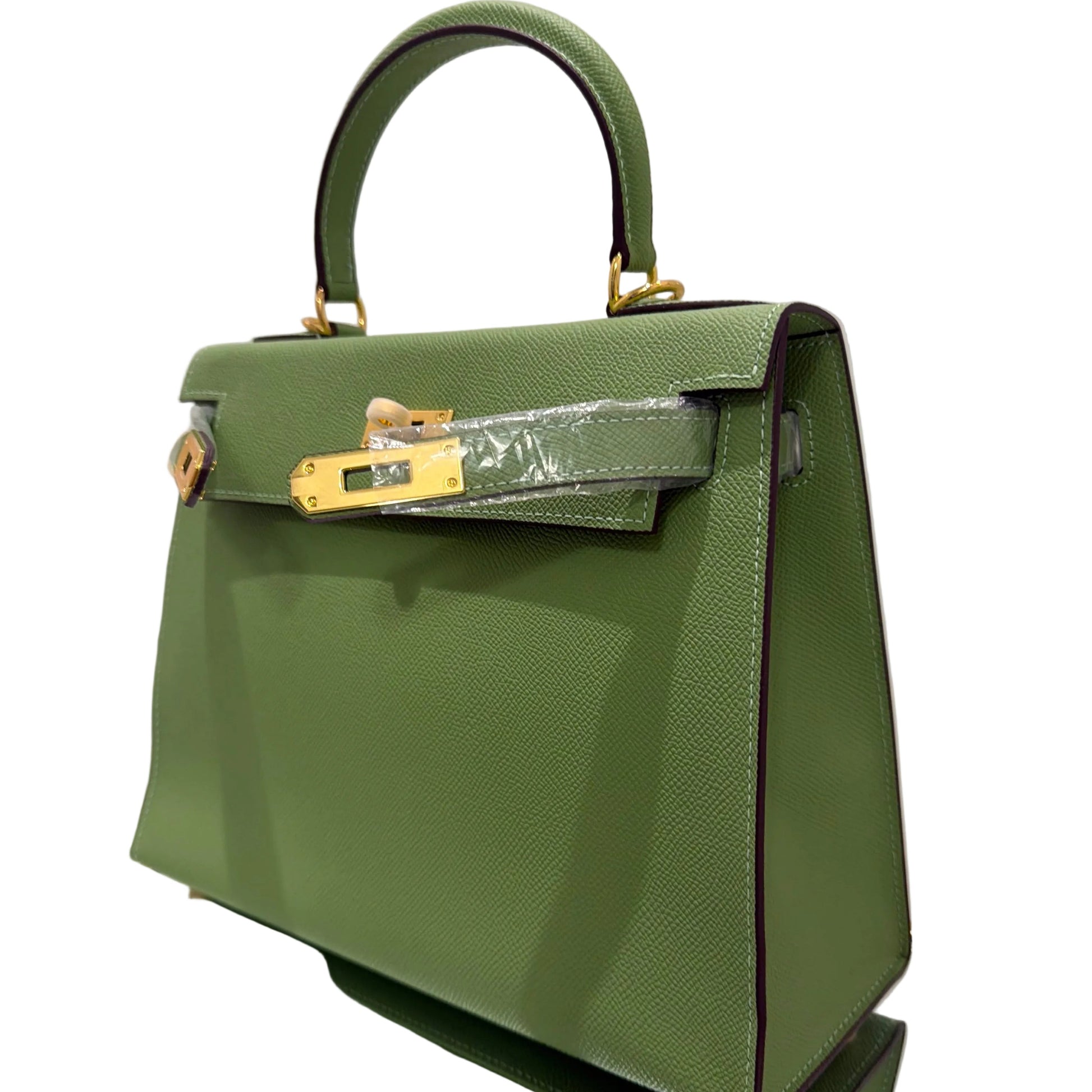 Green handbag with gold accents on a white background