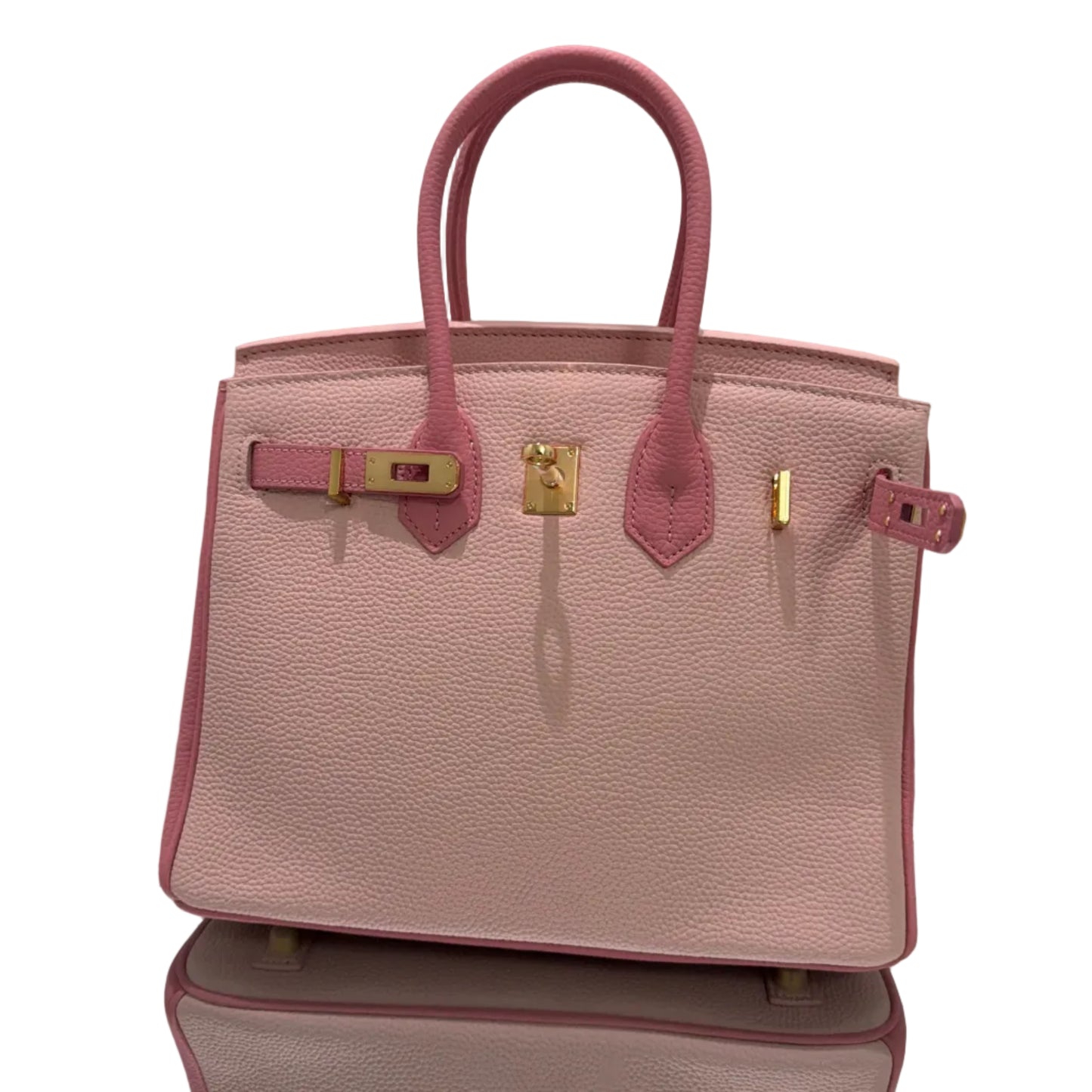 Pink handbag with gold hardware on a light gray background