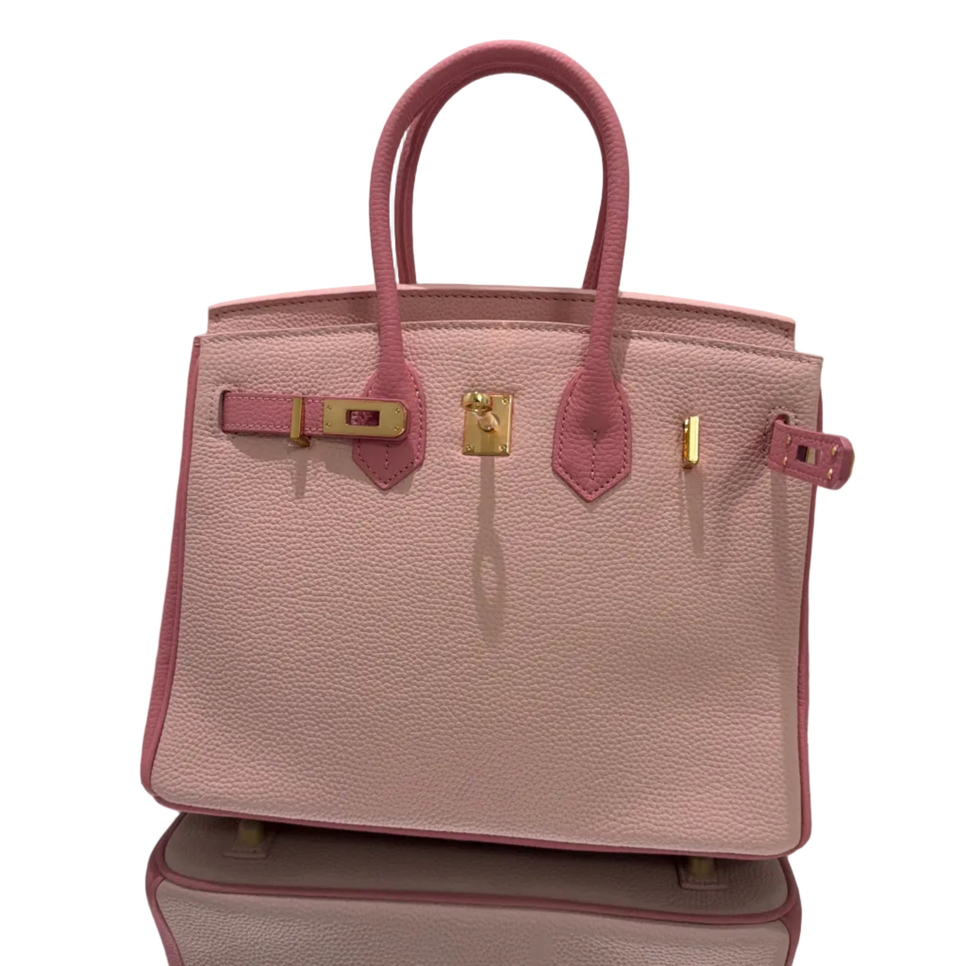 Pink handbag with gold hardware on a light gray background