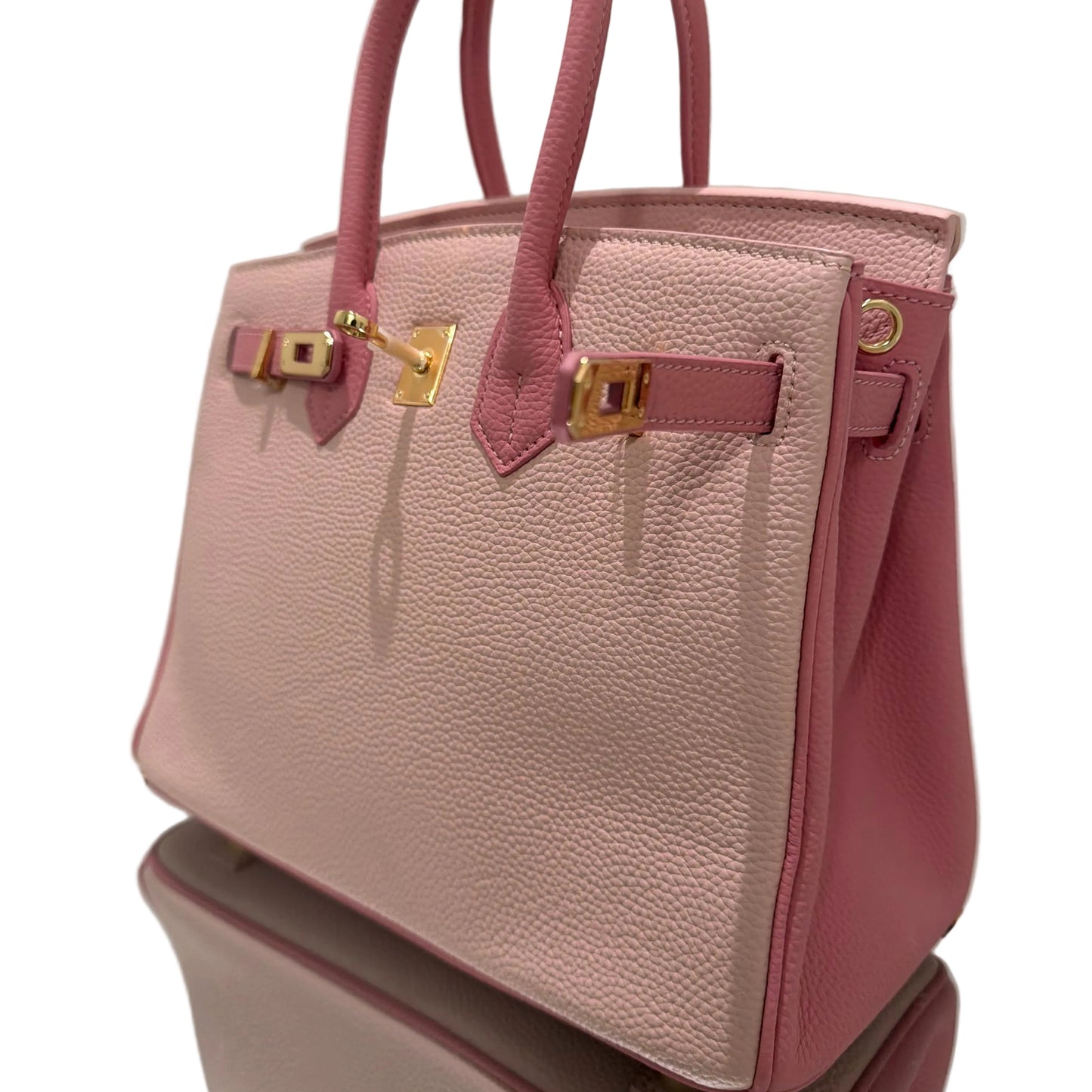 Pink handbag with gold hardware on a white background