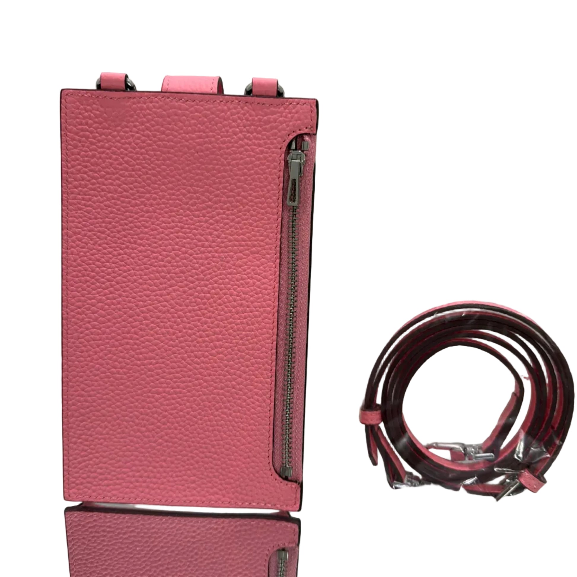 Pink leather wallet with matching strap on a light gray background