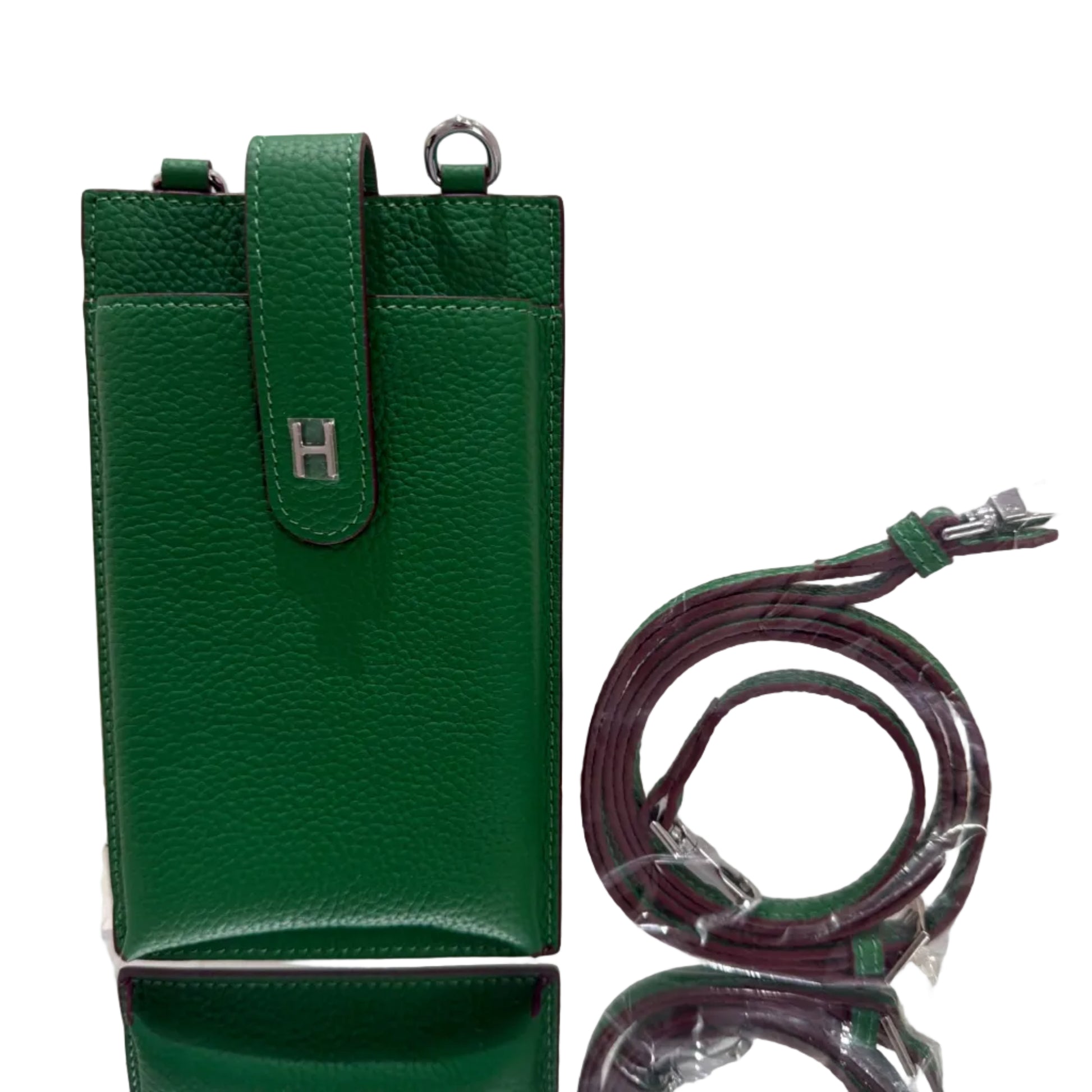 Green leather wallet with a strap on a light gray background