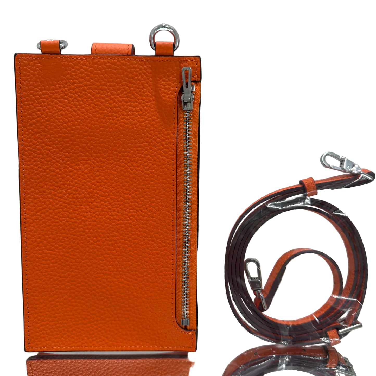 Orange leather pouch with a zipper and matching strap on a light gray background