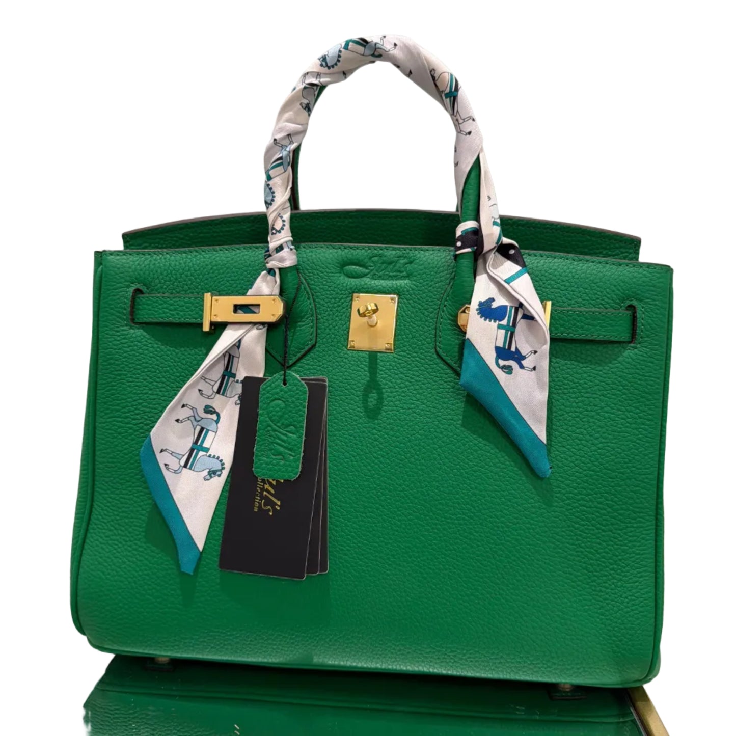 Green handbag with a matching scarf and tag on a white background