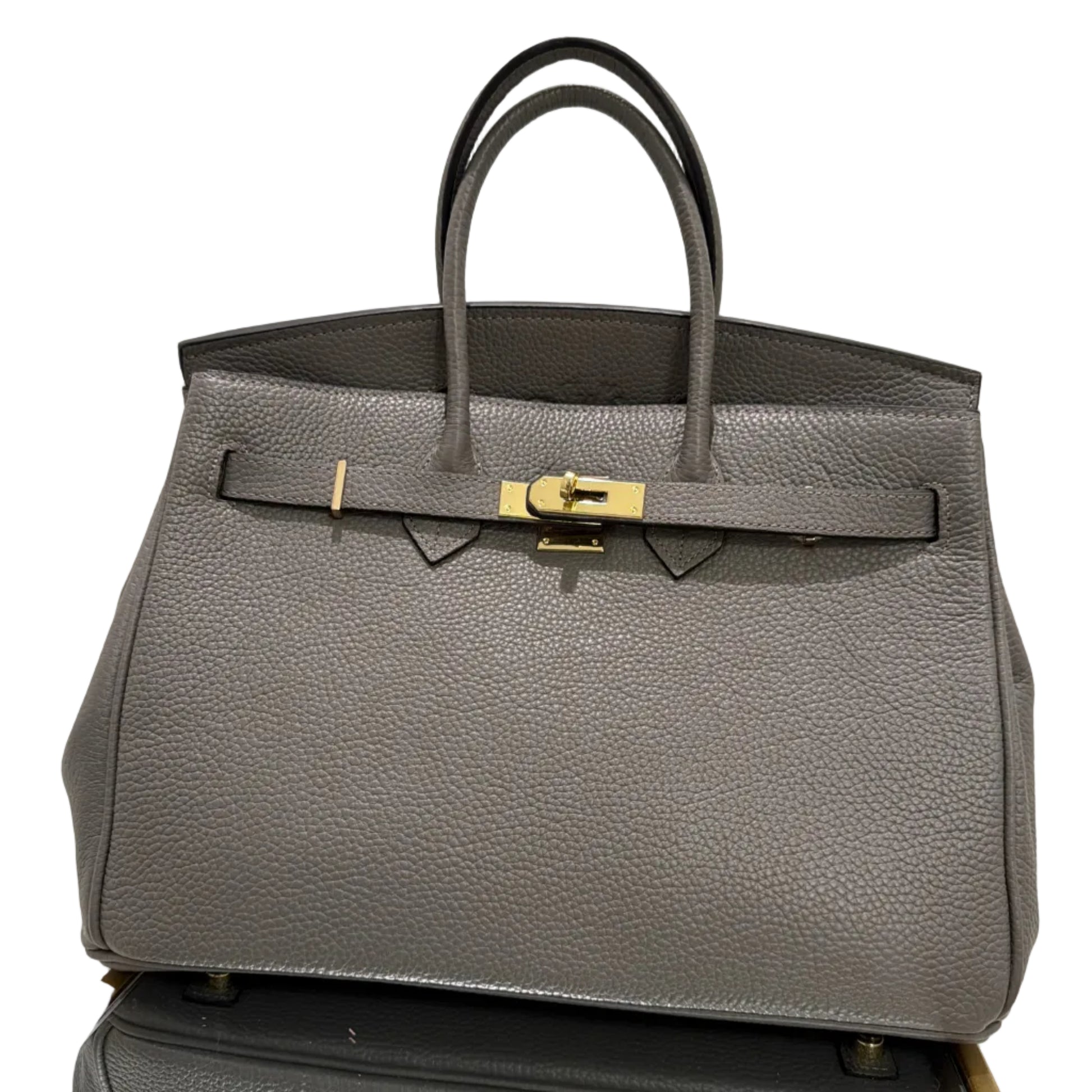 Gray textured handbag with gold clasp on a white background