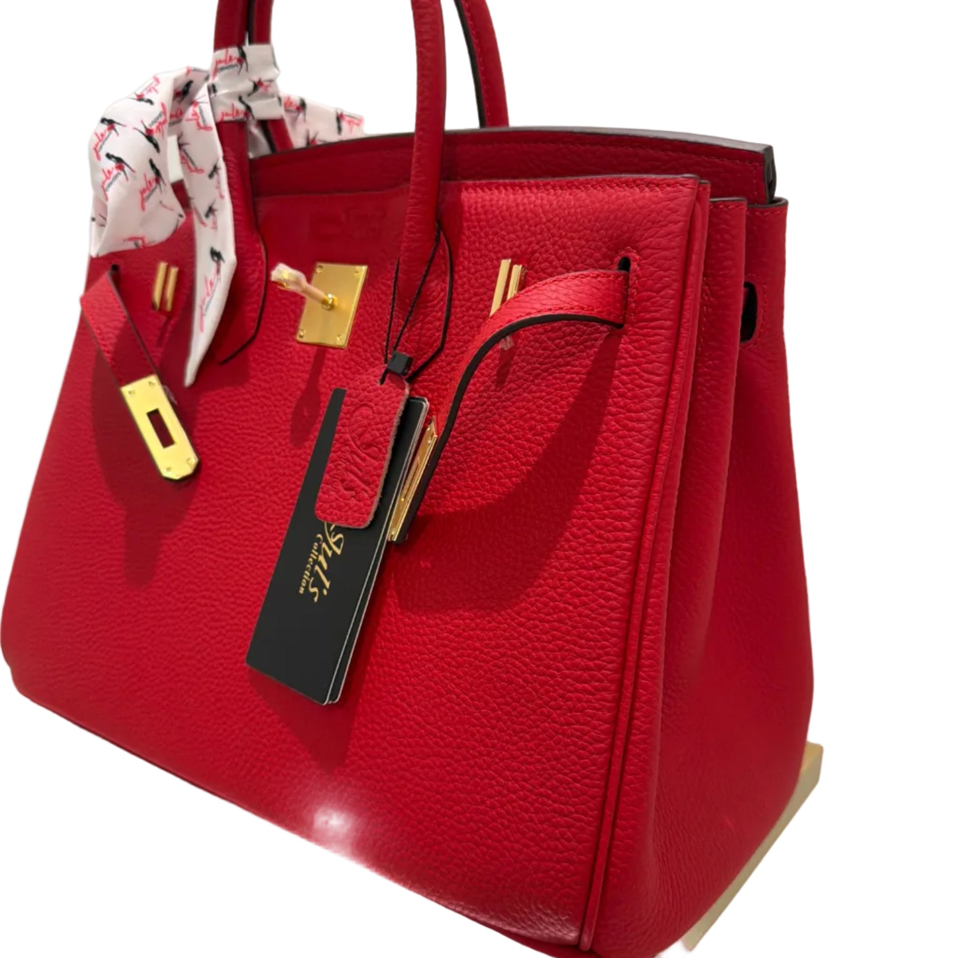 Red handbag with gold accents on a white surface