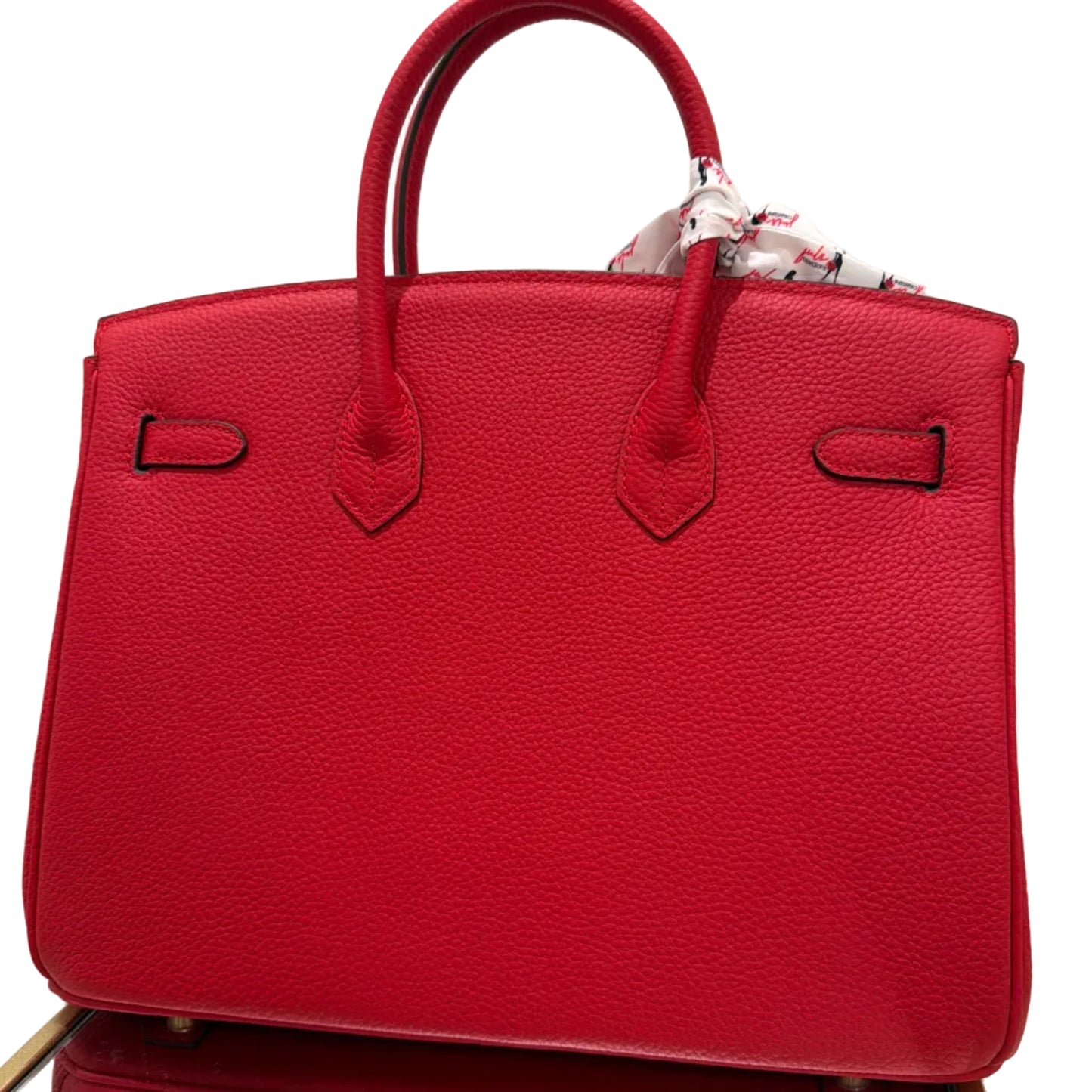 Red leather handbag with visible brand logo on a light background