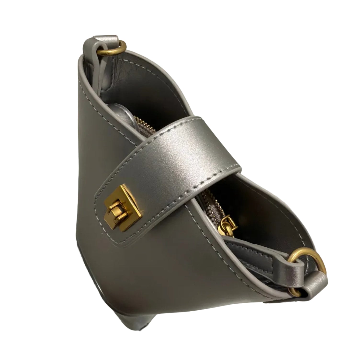 Gray handbag with gold accents on a reflective surface