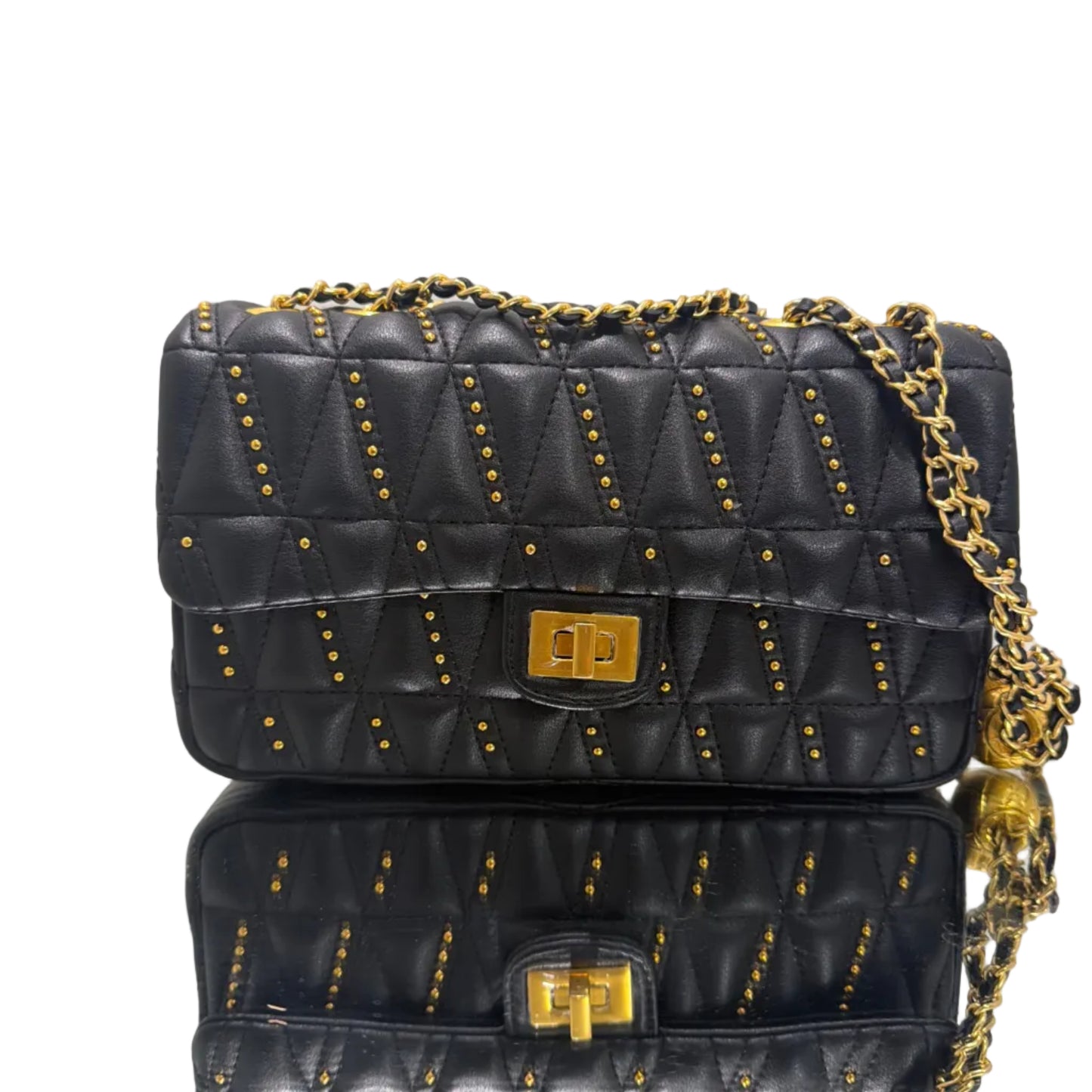 Black quilted handbag with gold chain and studs on a light gray background