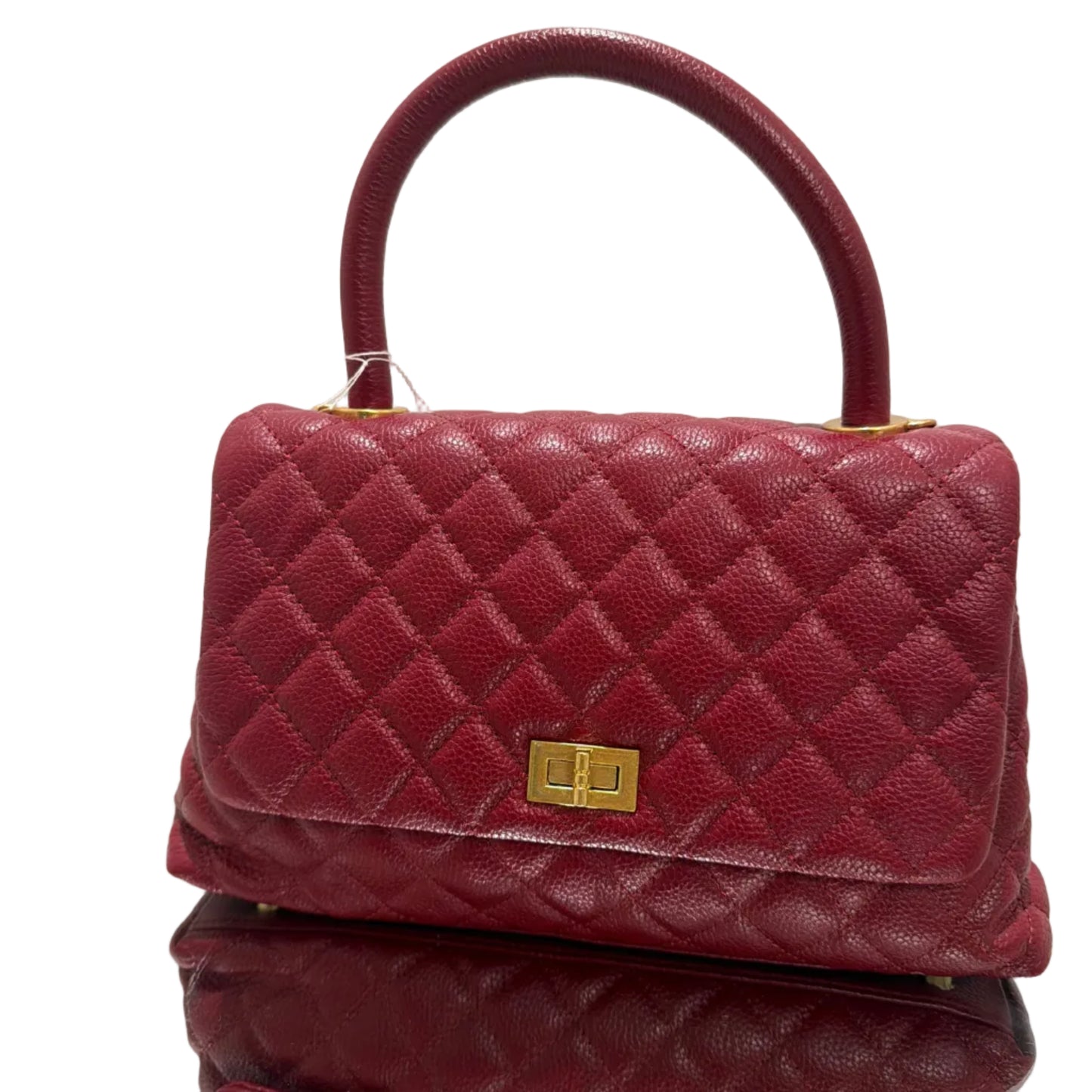 Quilted red handbag with gold clasp on a light background