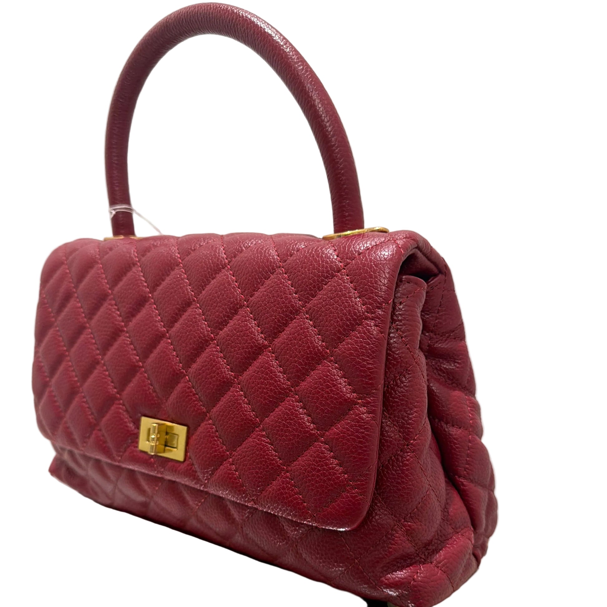 Maroon quilted handbag with gold hardware on a white background