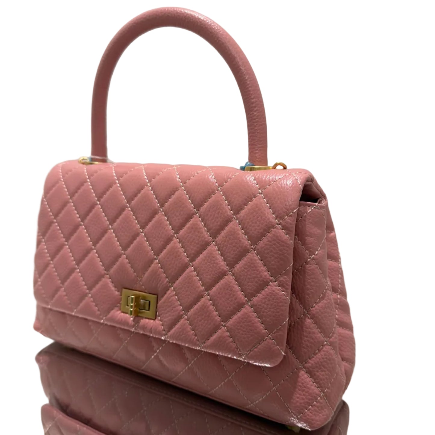 Pink quilted handbag with gold accents on a white background