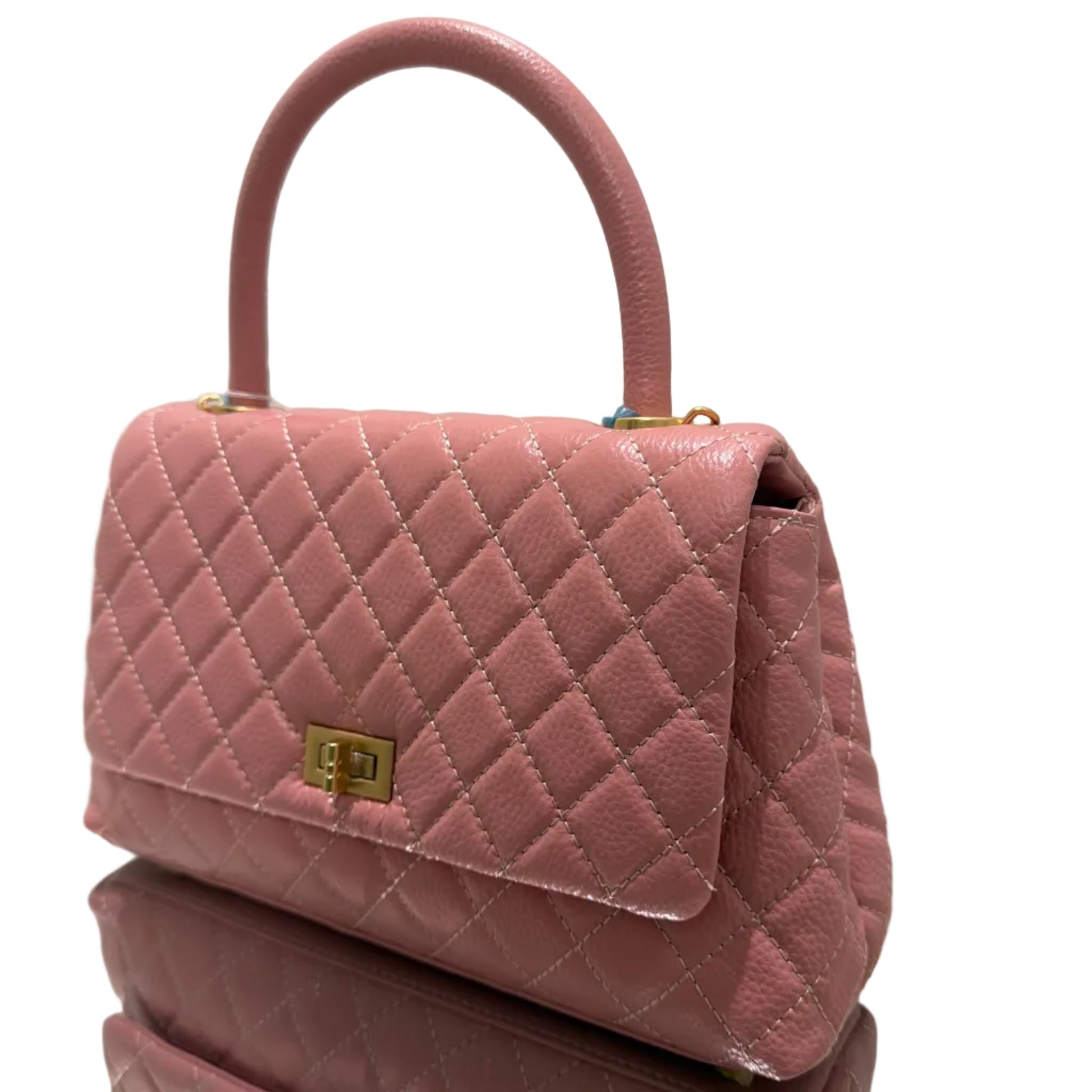 Pink quilted handbag with gold accents on a white background