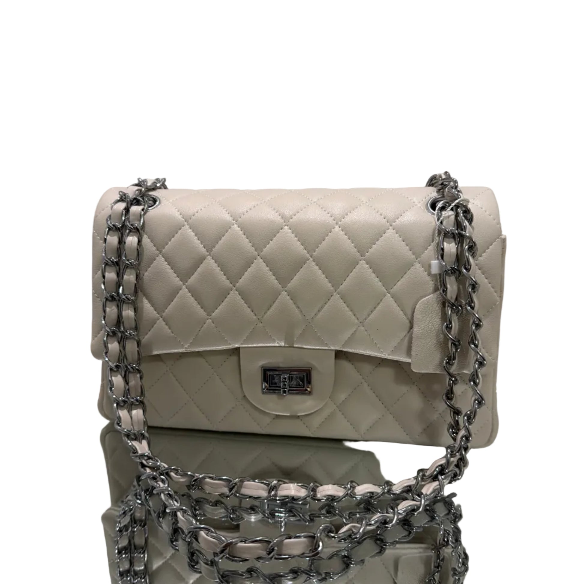 White quilted handbag with silver chain strap on a light gray background