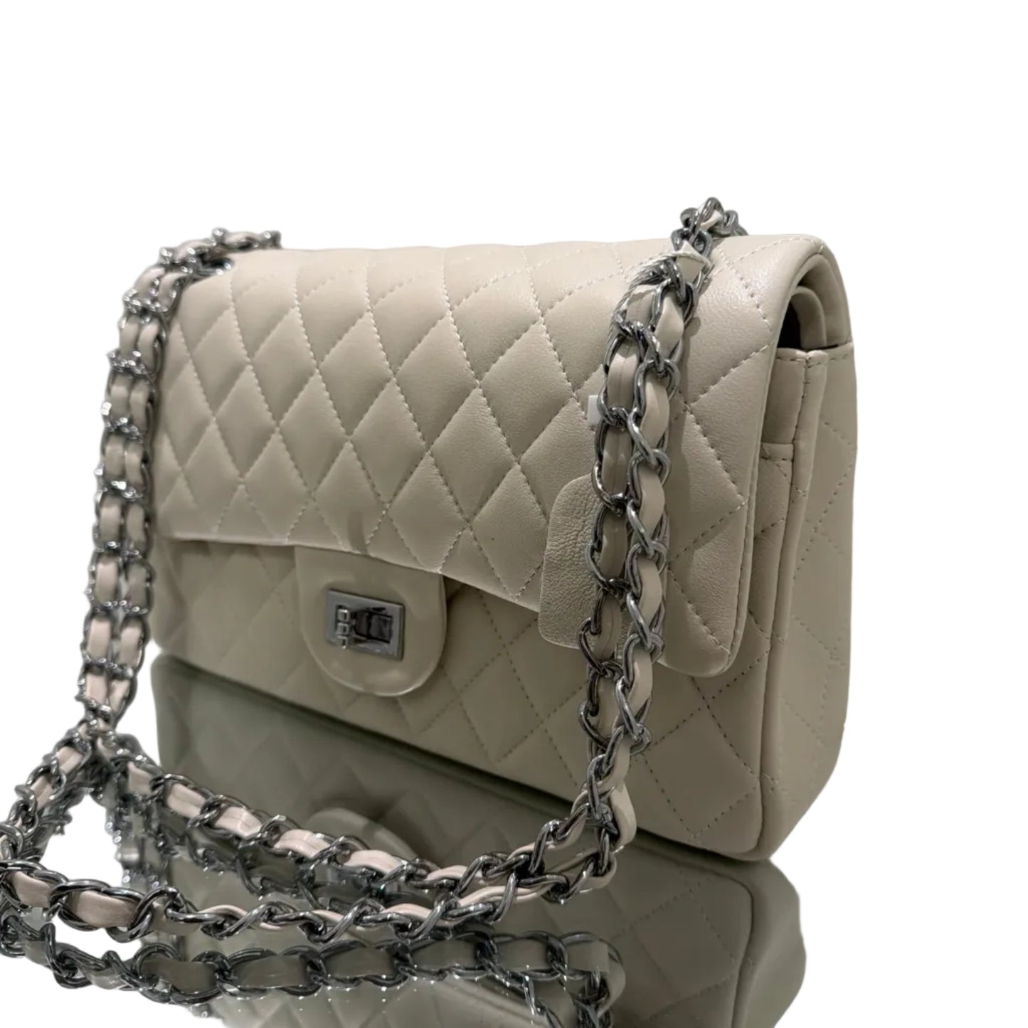 Beige quilted handbag with a chain strap on a white surface
