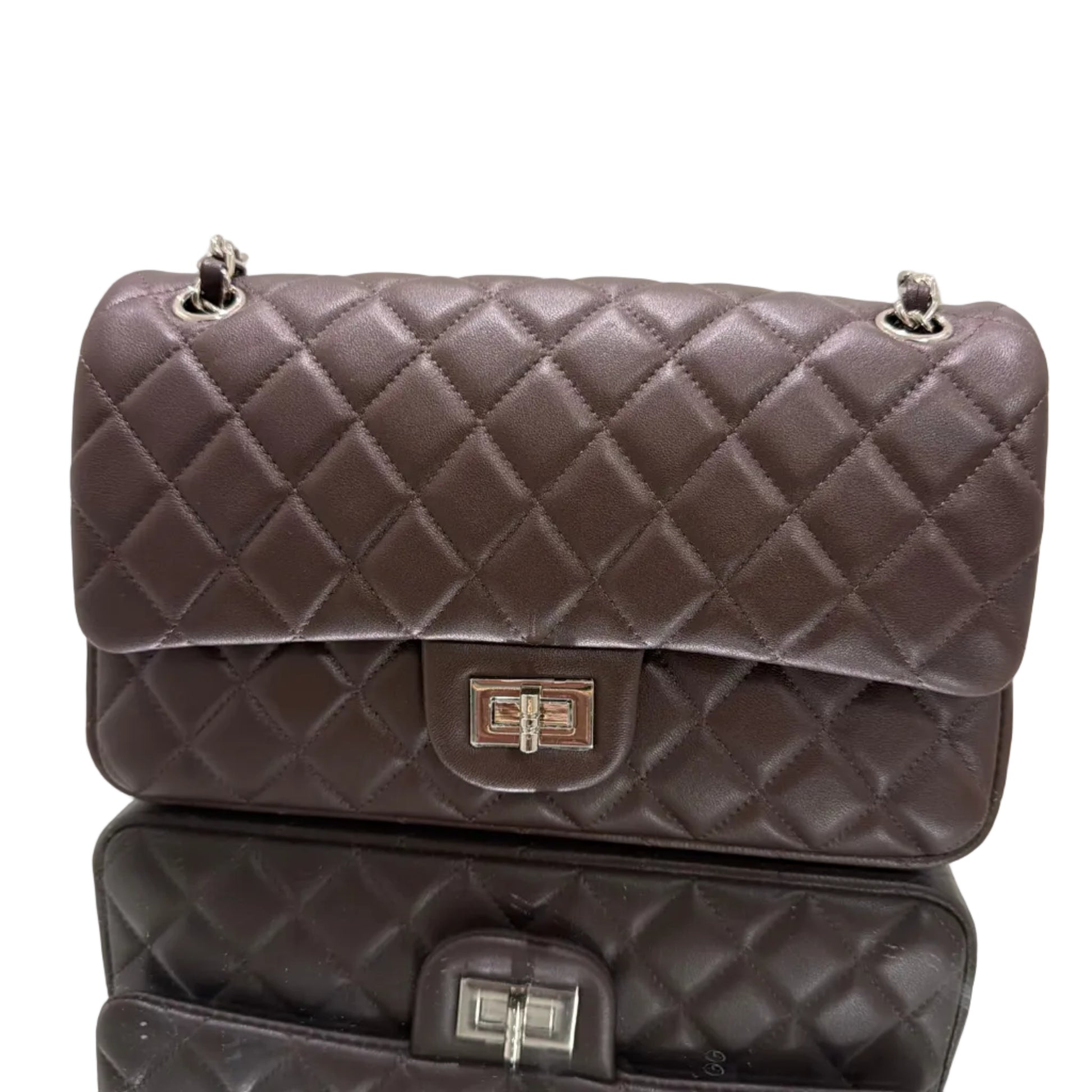 Two quilted handbags with visible brand logos on a light background