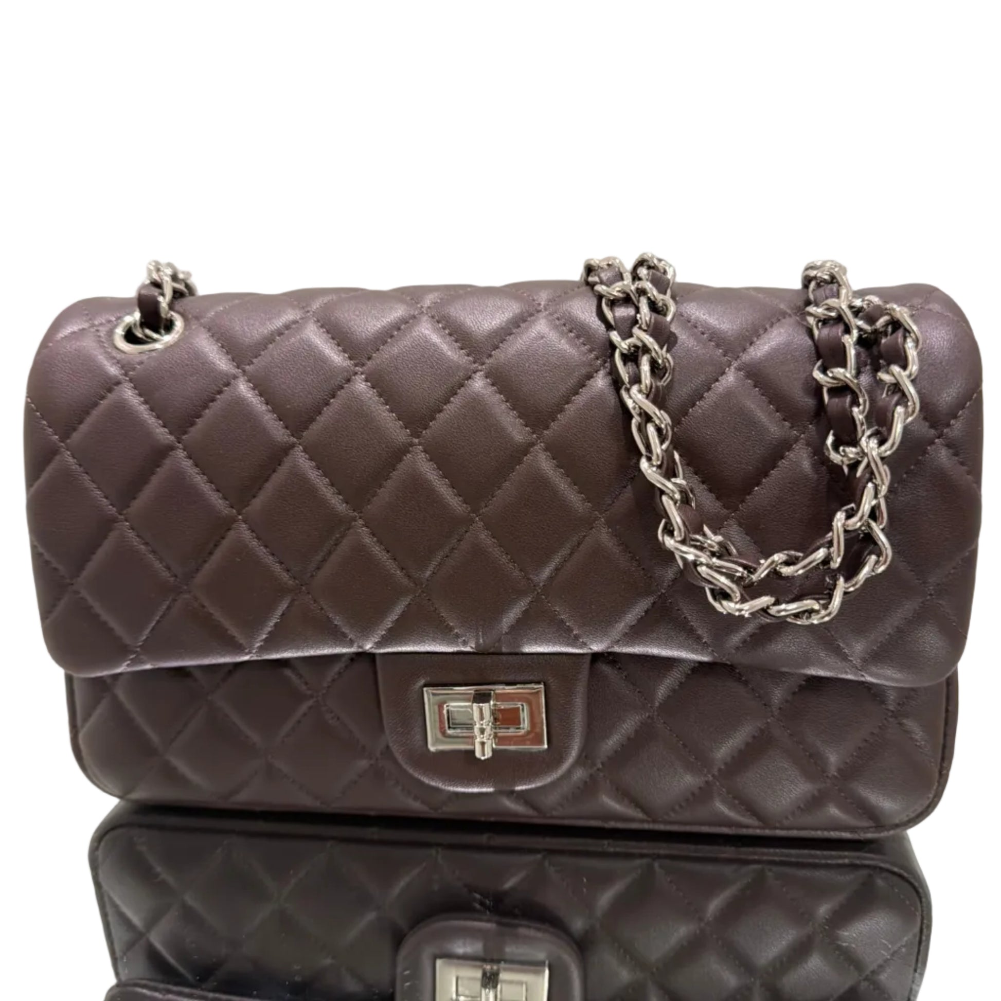 Quilted handbags with chain detail on a light gray background