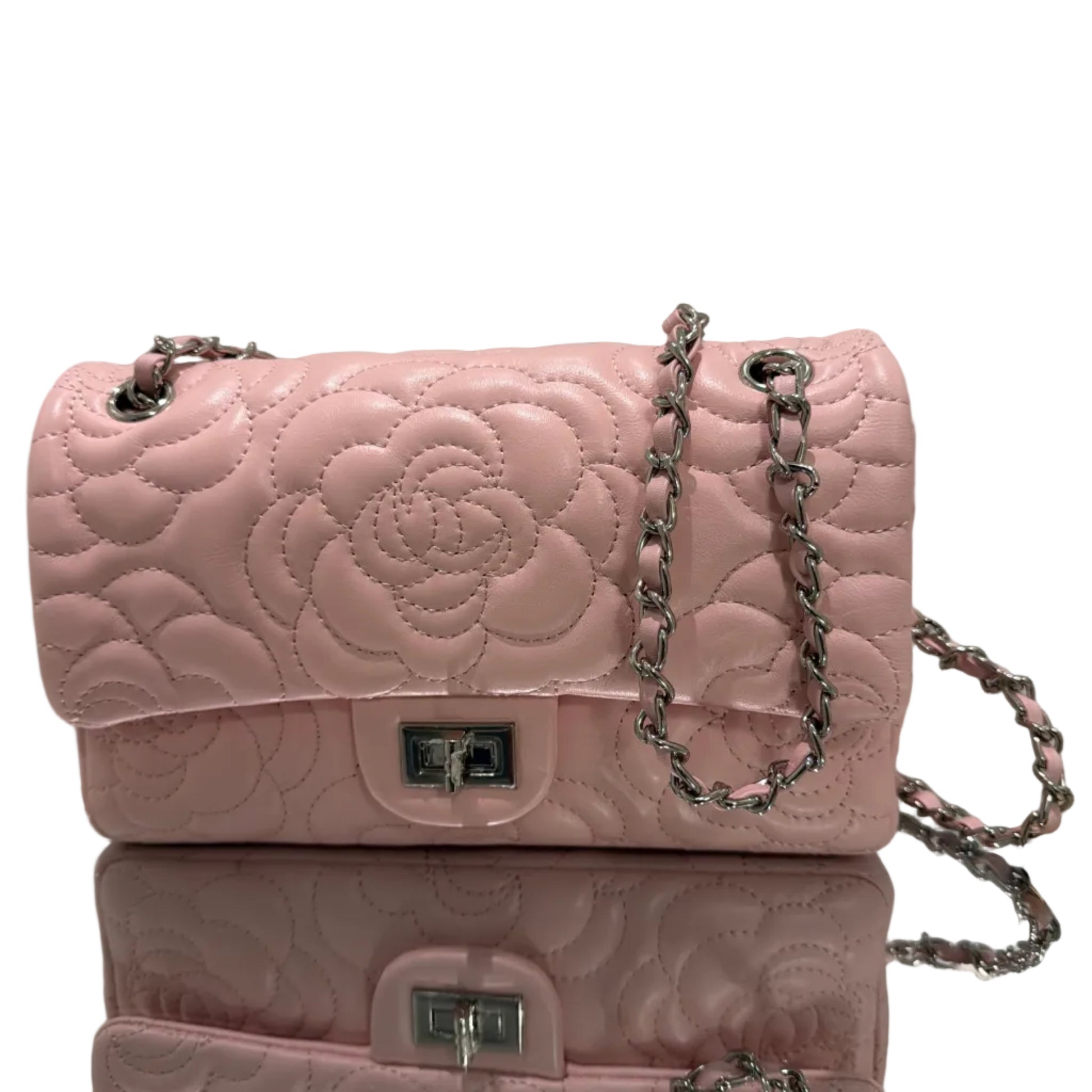 Pink quilted handbag with chain detail on a gray background