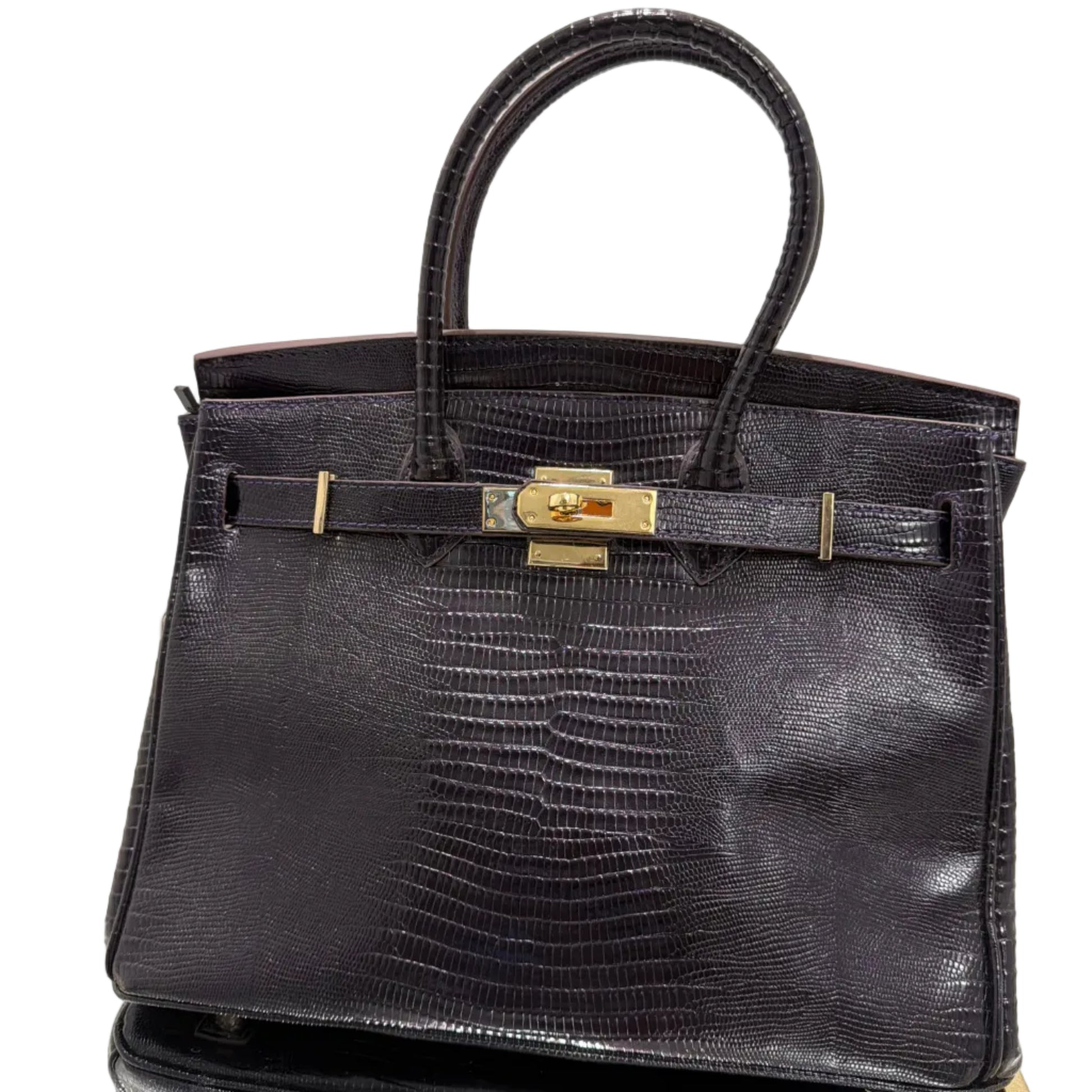 Black textured handbag with a gold clasp on a light background