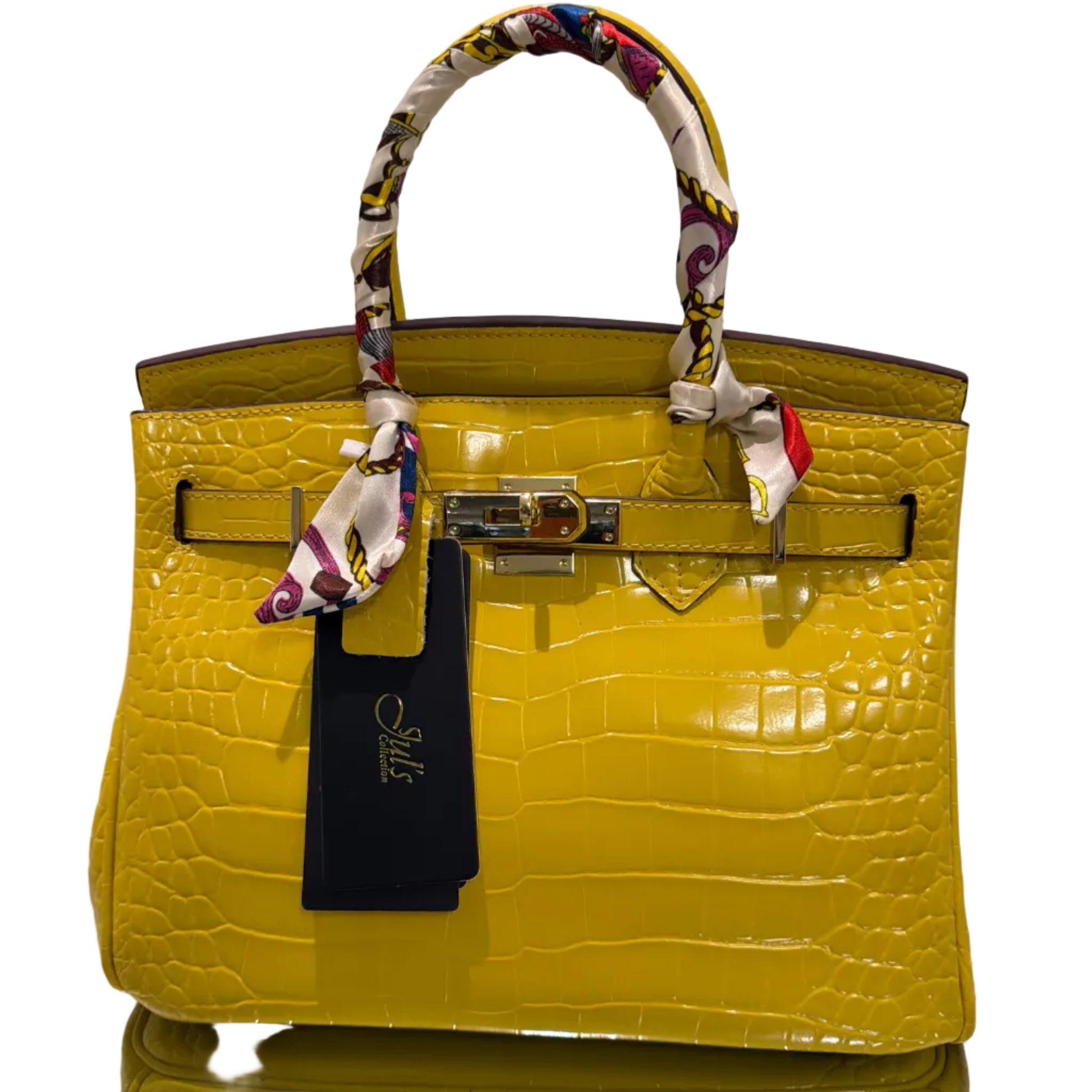 Yellow crocodile-patterned handbag with a matching pouch on a white background