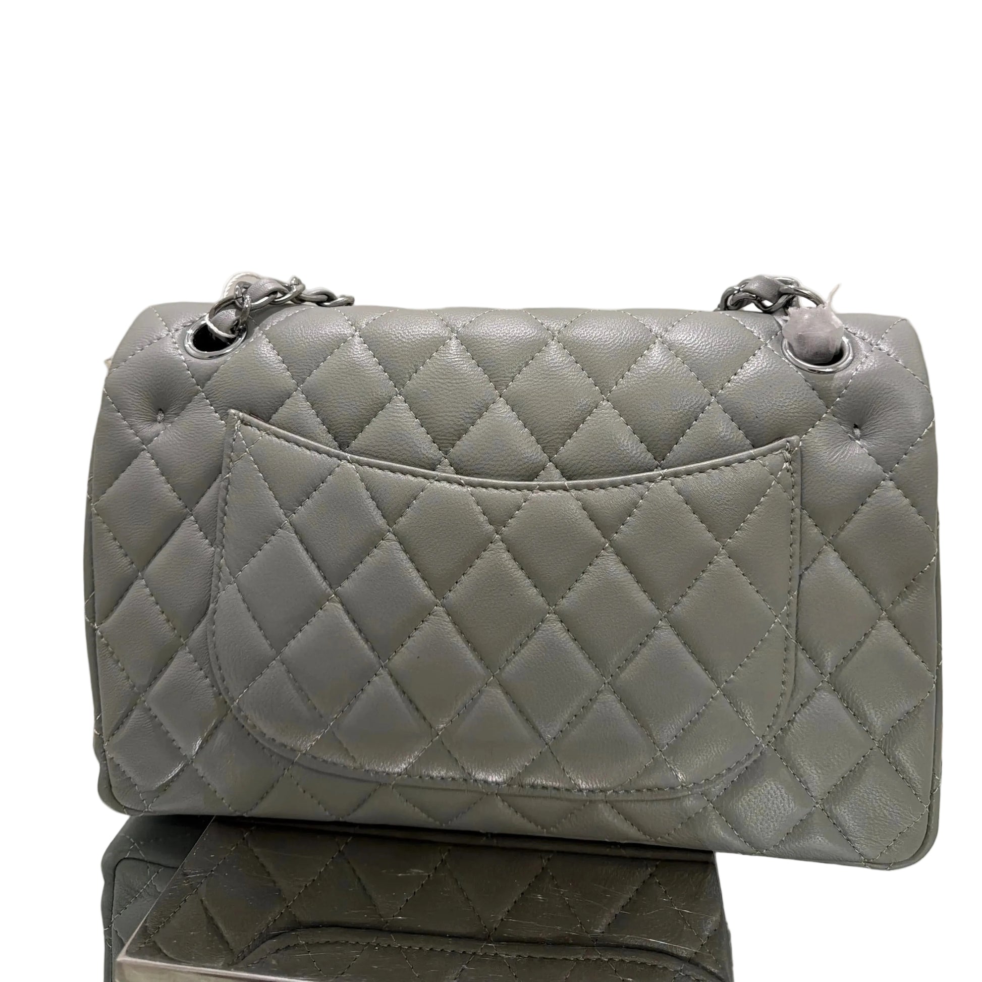 Gray quilted handbag on a white background