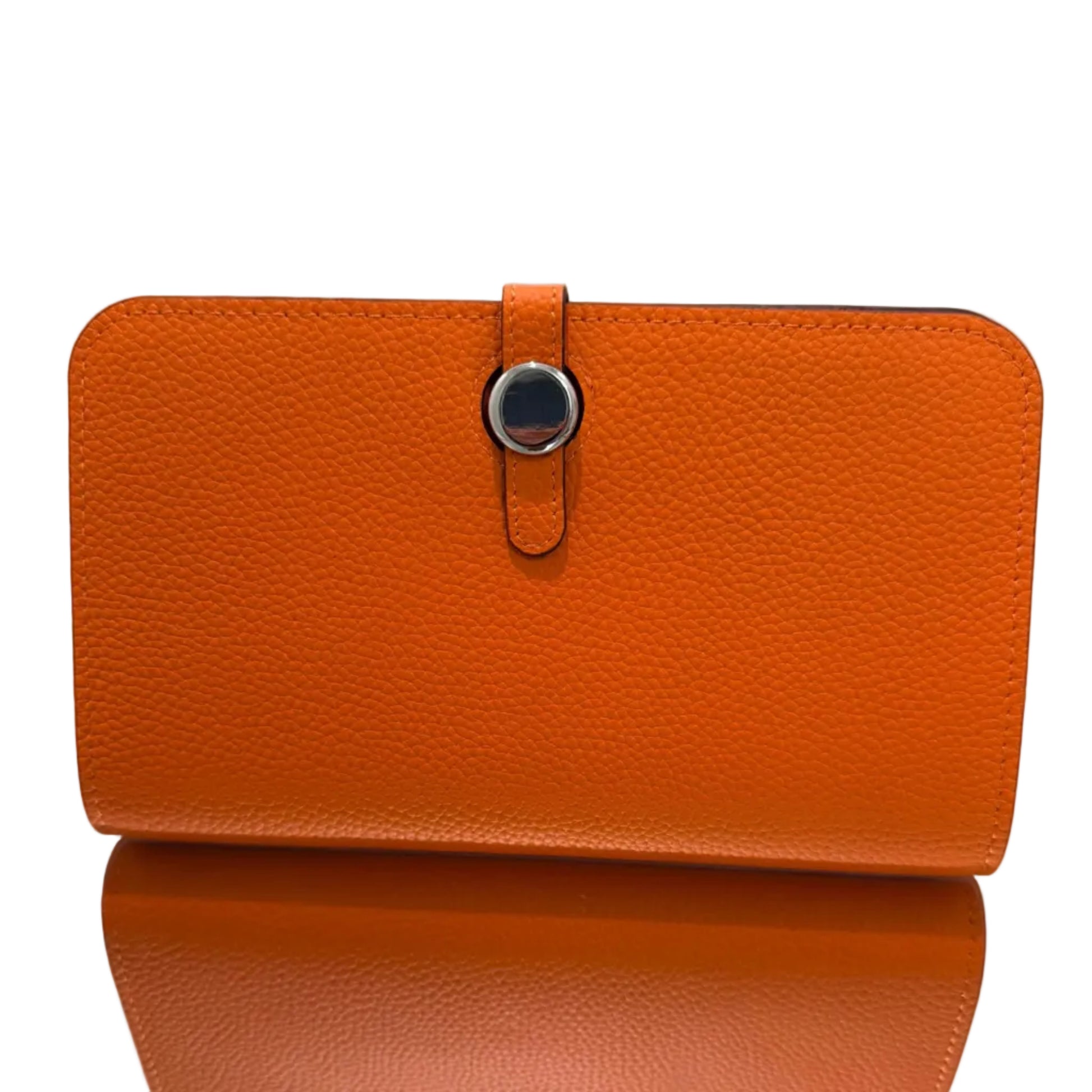 Orange leather wallet with a strap on a light gray background