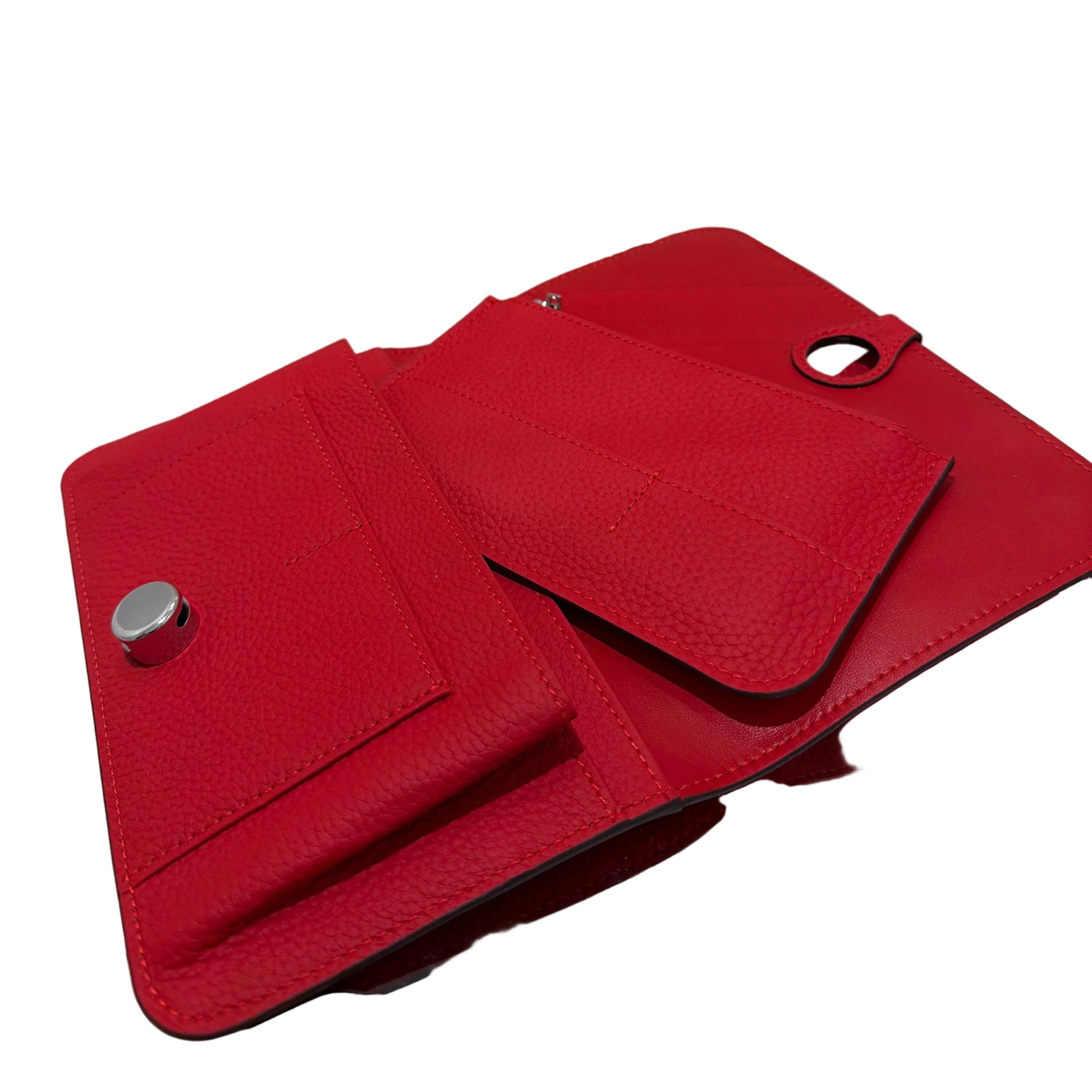 Red wallet with silver buttons on a clear stand against a white background