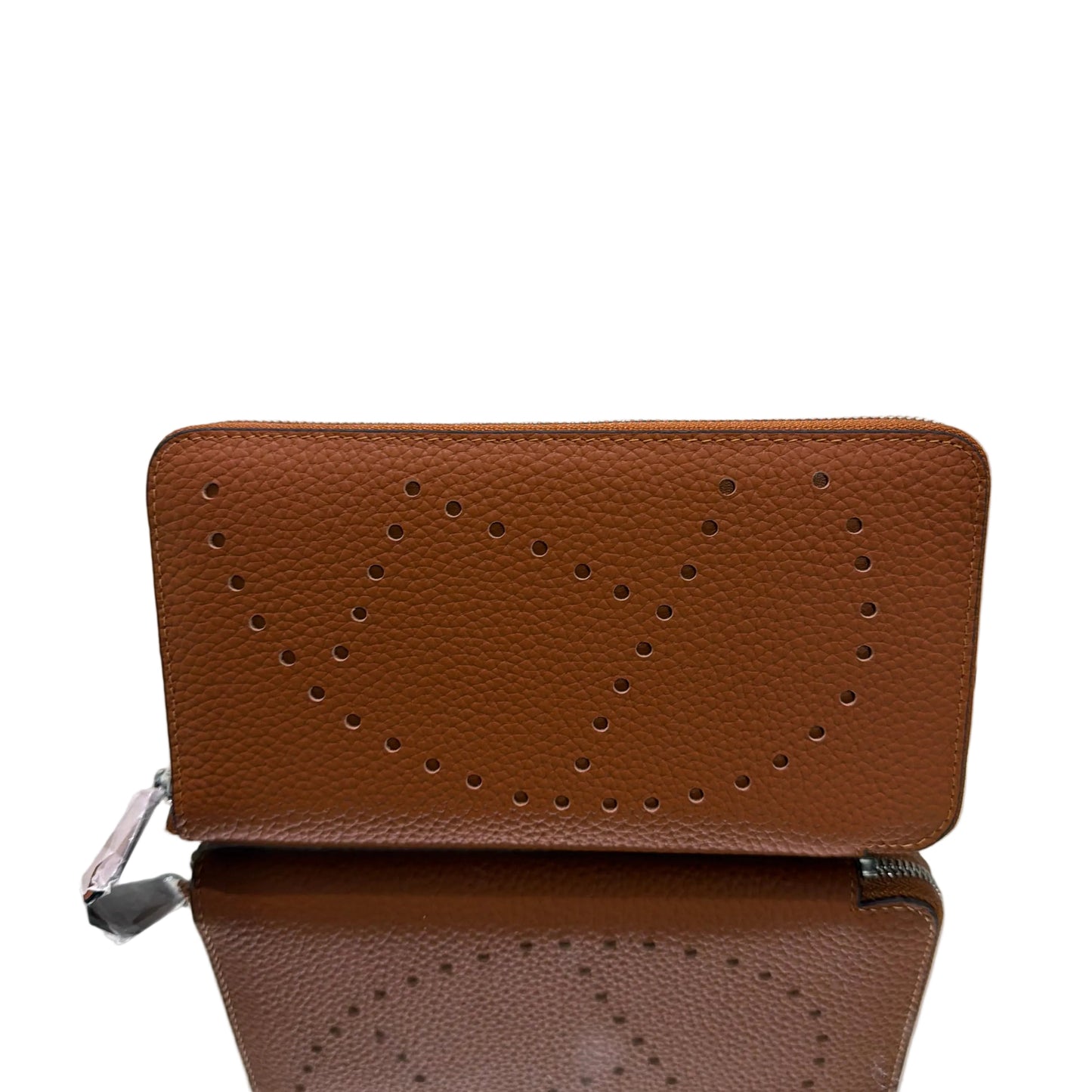 Brown leather wallet with star pattern on a reflective surface