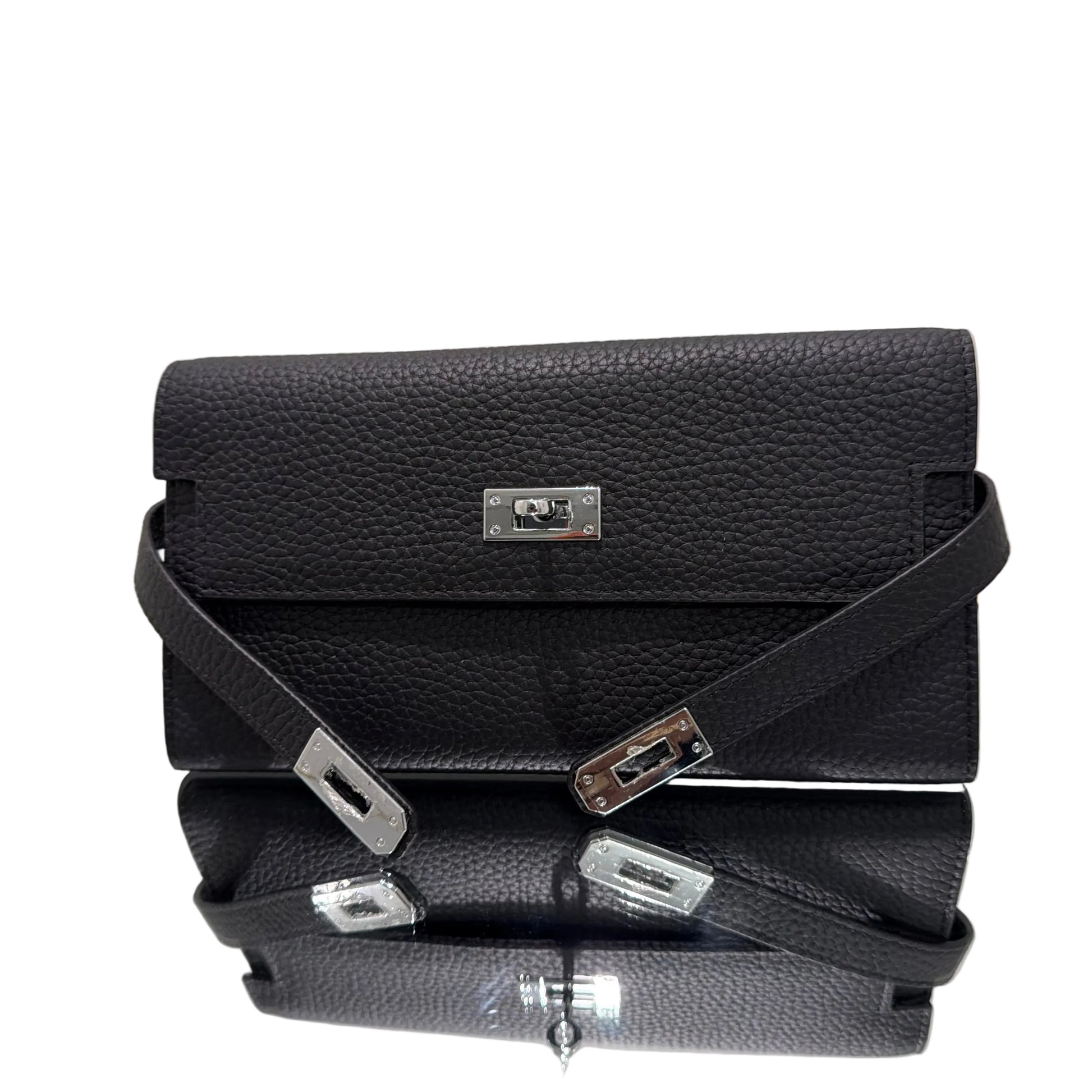 Black leather handbag with silver hardware on a light gray background