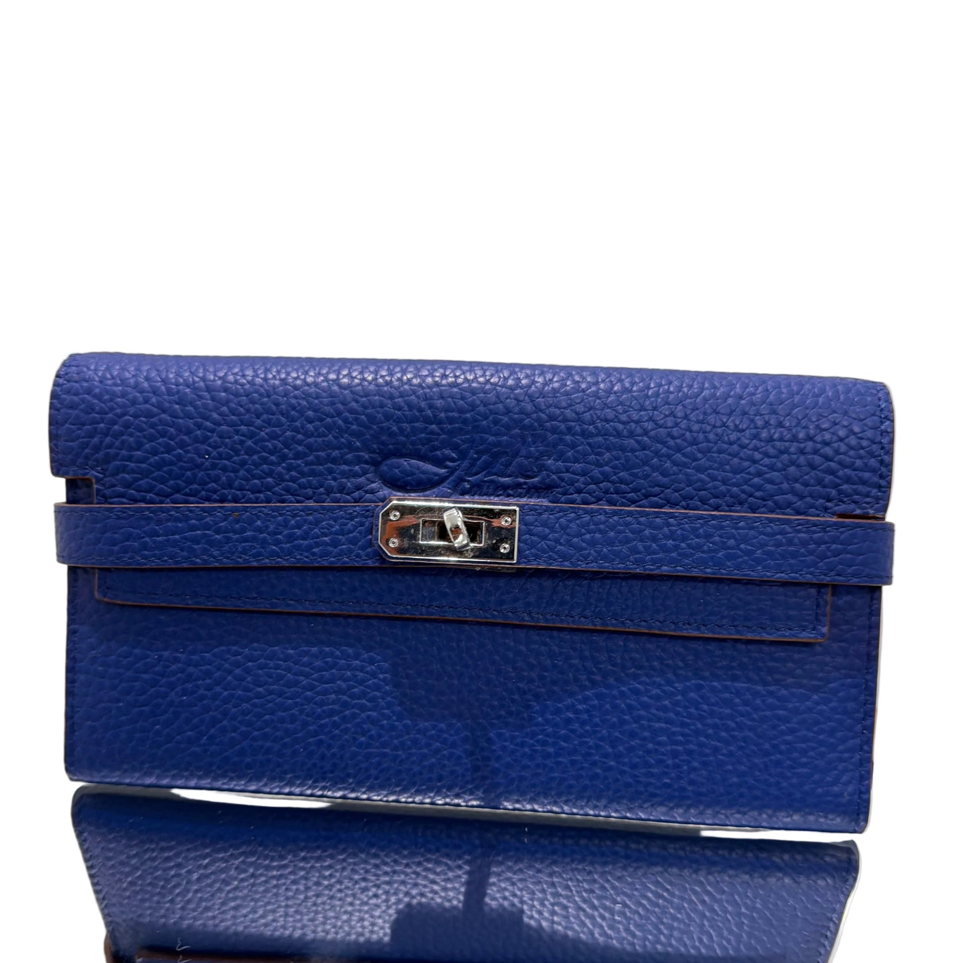 Two blue leather handbags with silver zippers on a light gray background