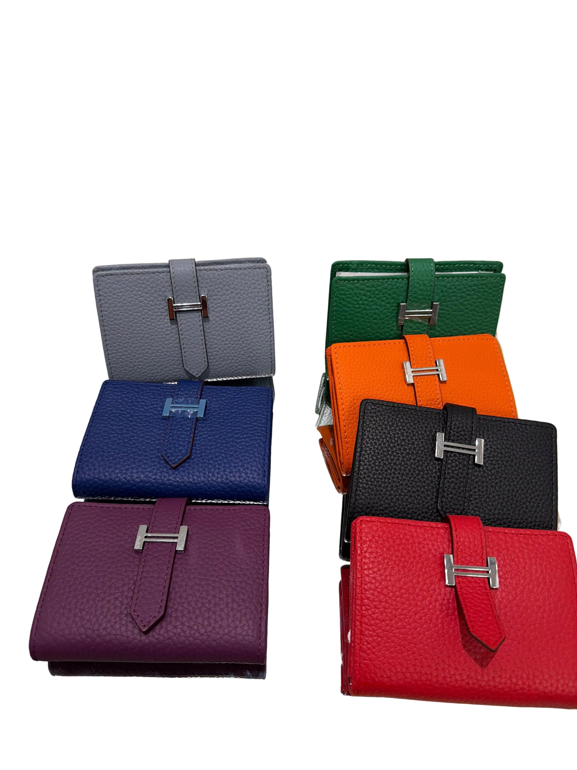Set of colorful leather wallets displayed on a stand.