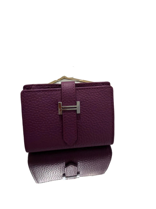 Purple textured wallet with silver clasp on a white background