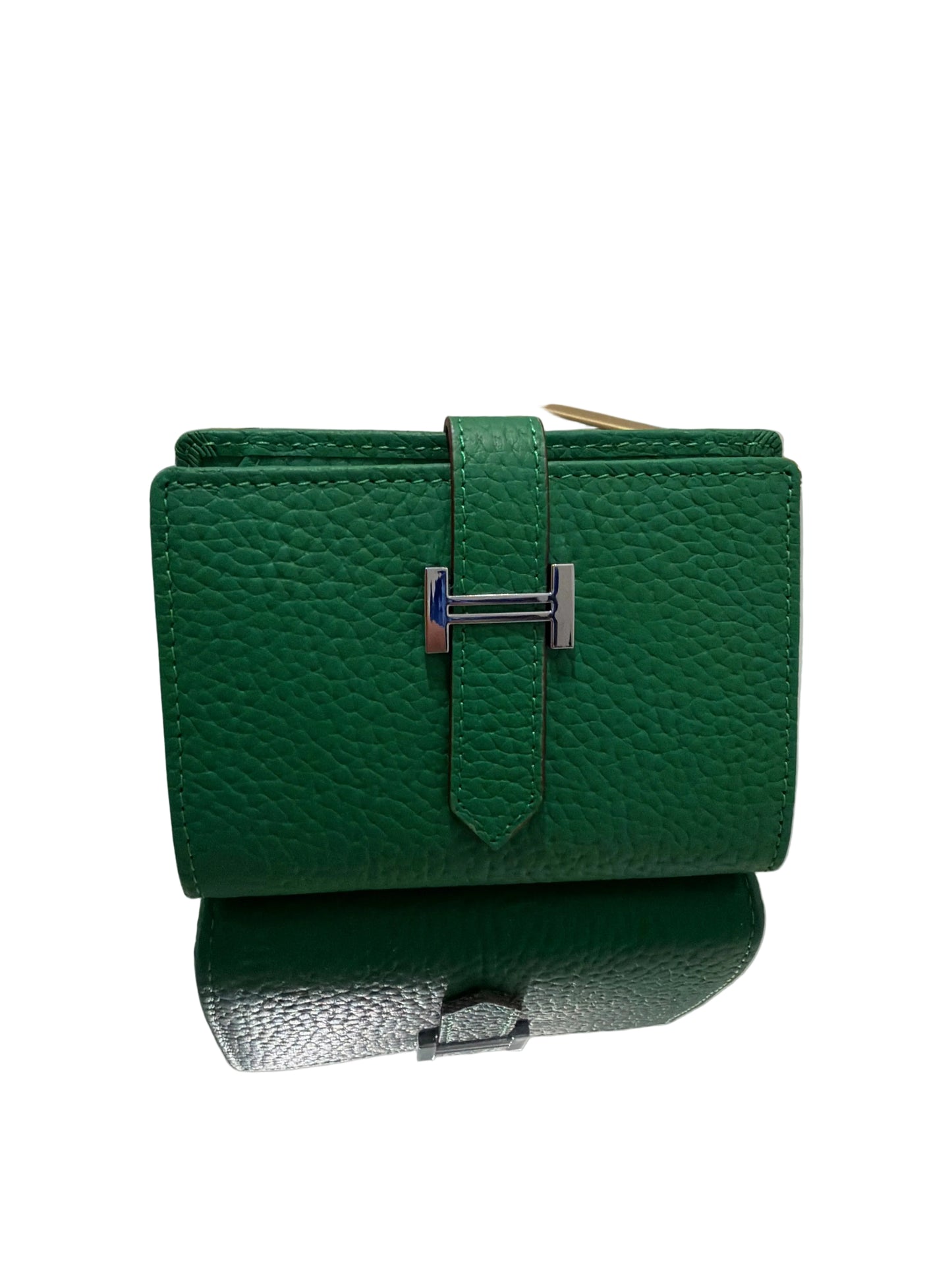 Green leather handbag with a silver clasp on a white background