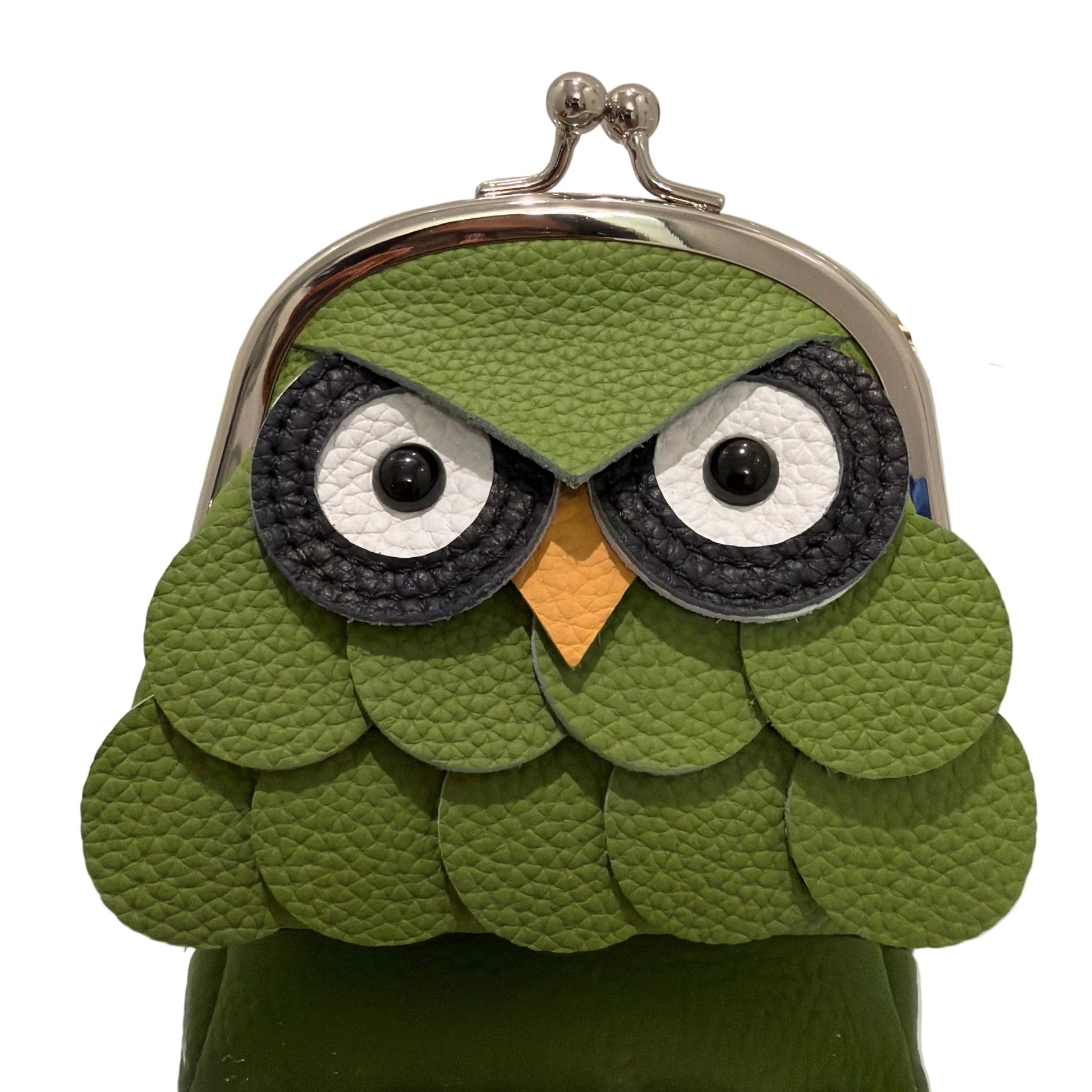 Green owl-shaped pouch with a mirror on a white background