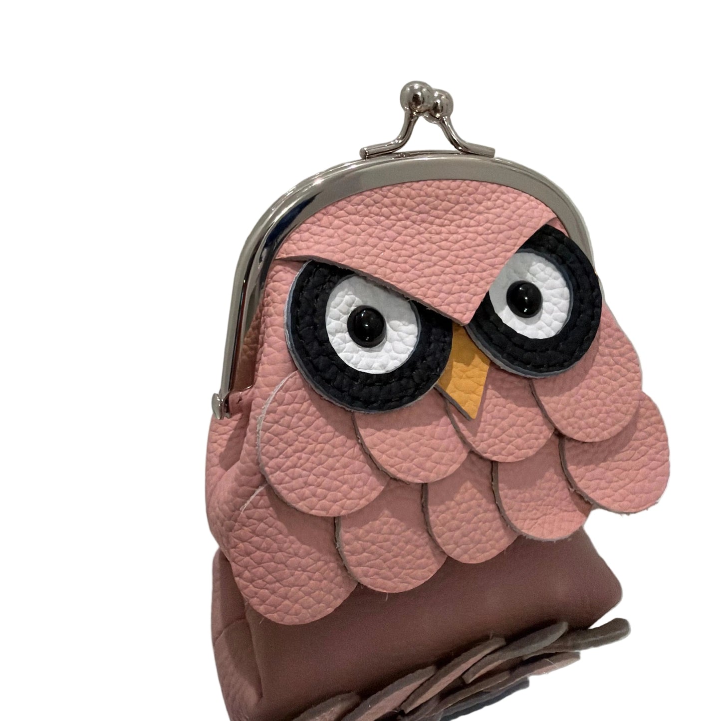 Pink owl-shaped coin purse on a white surface