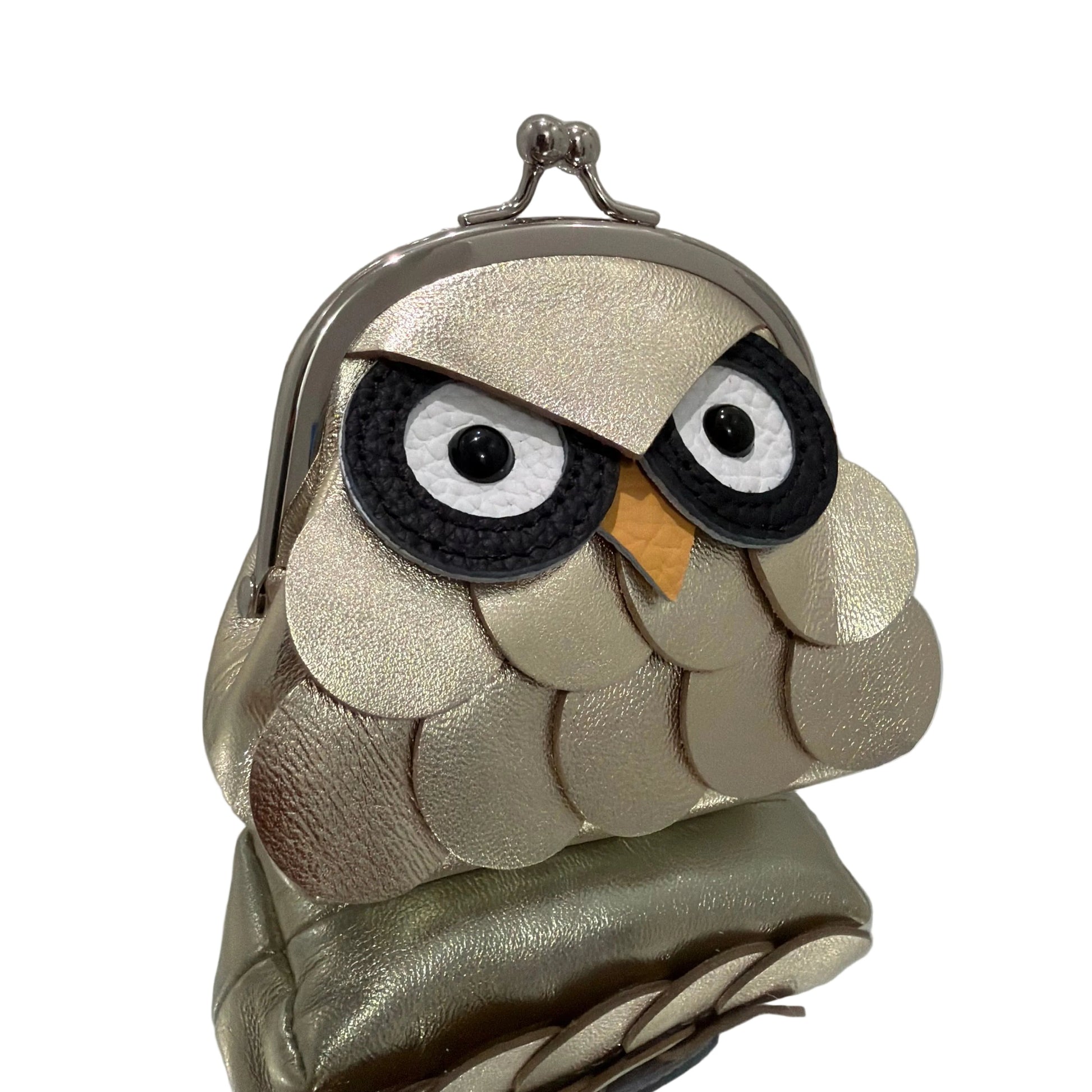 Owl-shaped handbag with metallic finish on a white background