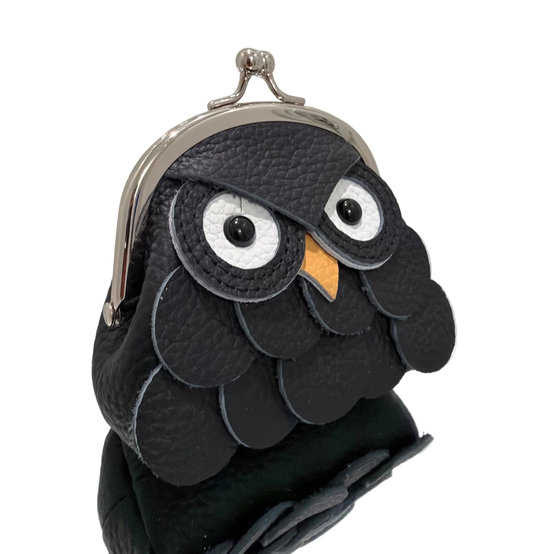 Black owl-shaped pouch with a mirror on a white background